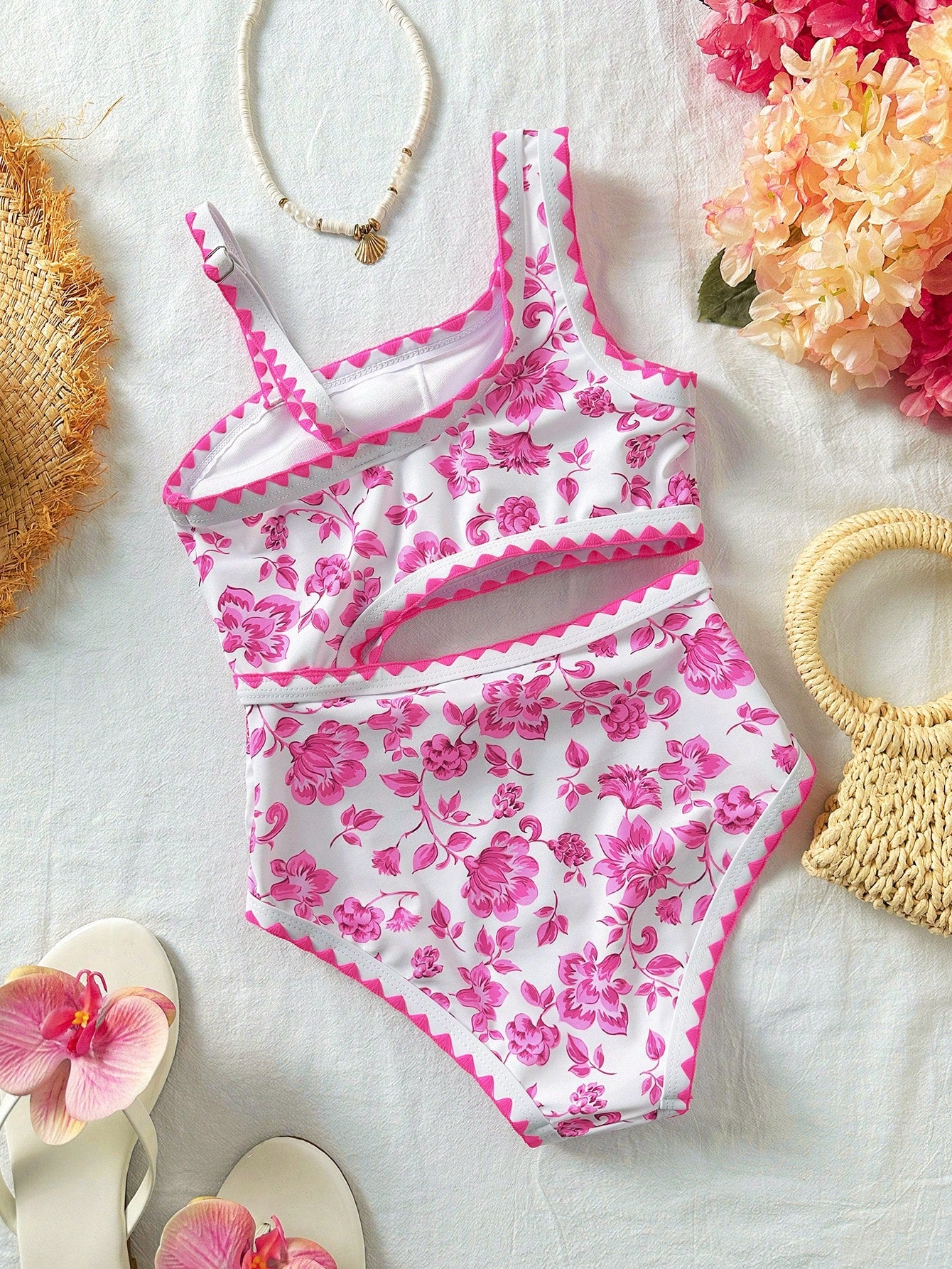 Tween girls one-piece swimsuit featuring an asymmetric neckline, pendant decor, plain design, wireless bra, high-cut bottom, and medium-stretch fabric.