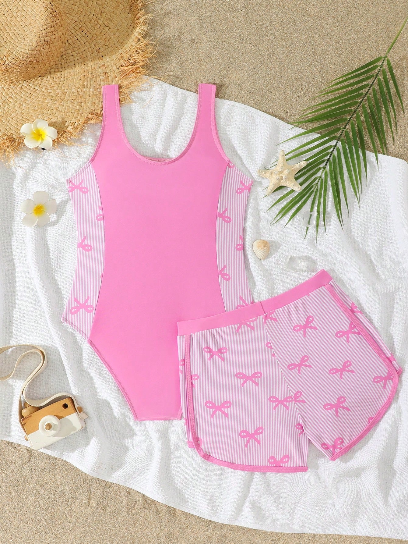 Tween girls 2-piece swimsuit set in black with full floral and plant print, featuring a sleeveless scoop-neck swim top and matching shorts-style bottoms.