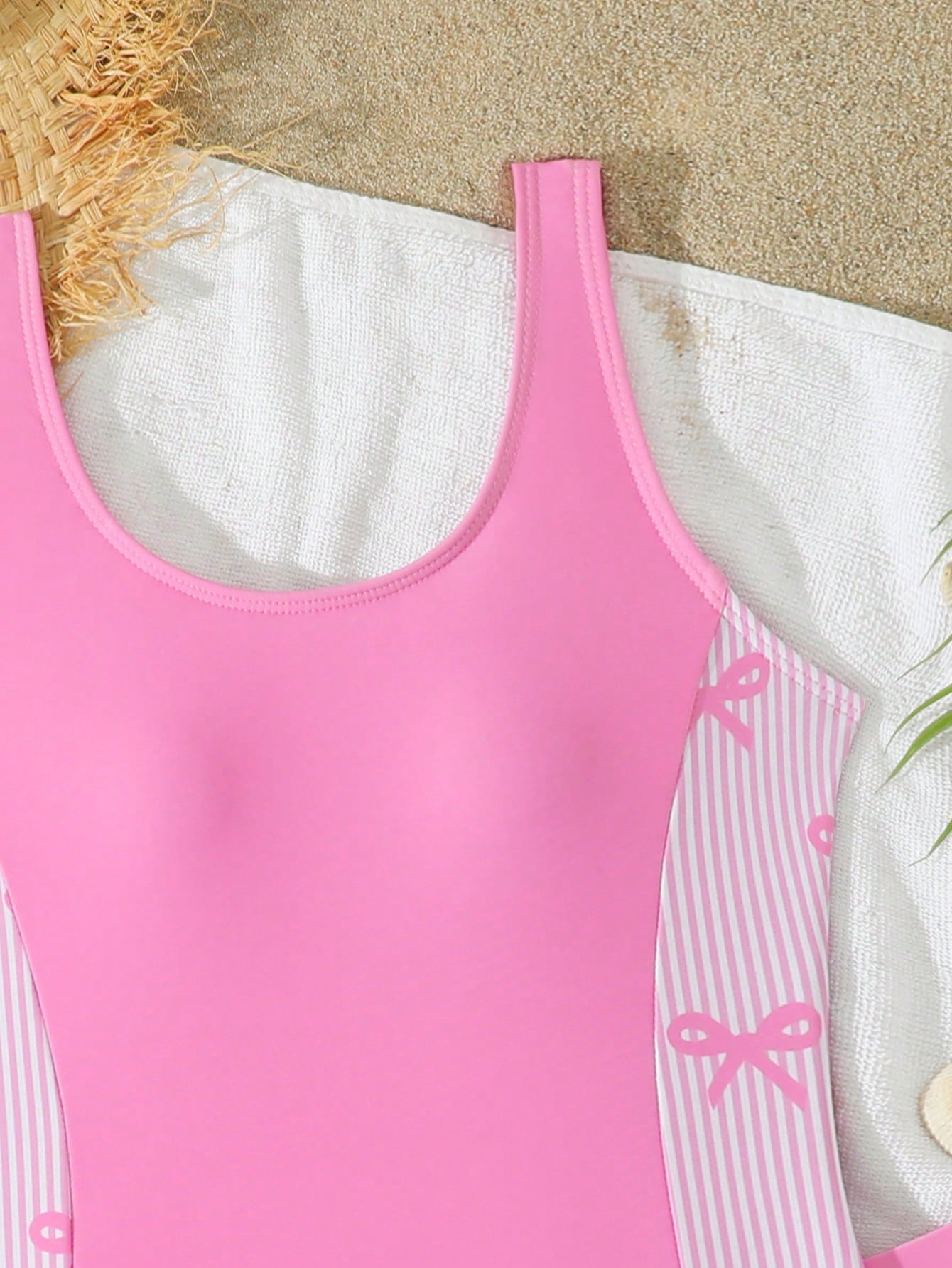 Tween girls 2-piece swimsuit set in black with full floral and plant print, featuring a sleeveless scoop-neck swim top and matching shorts-style bottoms.