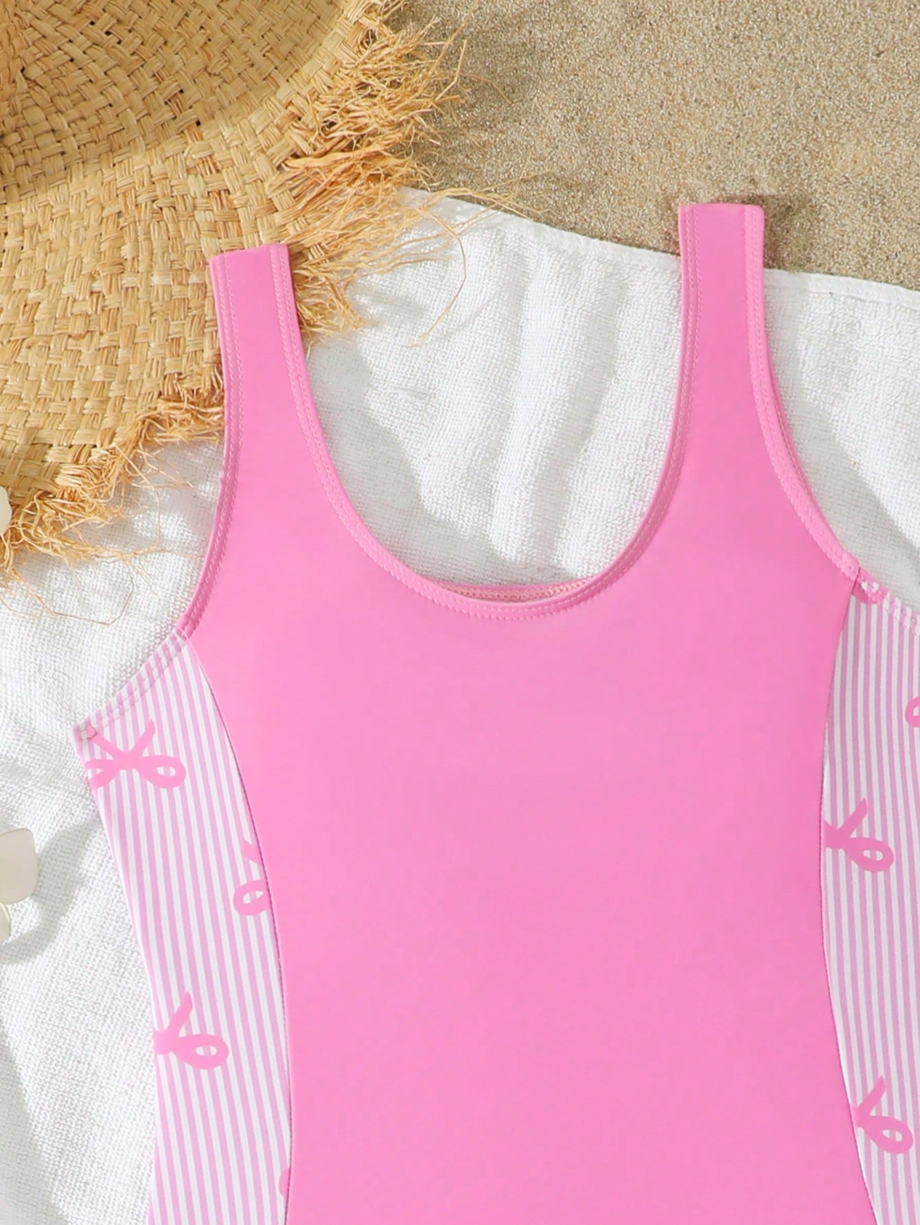 Tween girls 2-piece swimsuit set in black with full floral and plant print, featuring a sleeveless scoop-neck swim top and matching shorts-style bottoms.