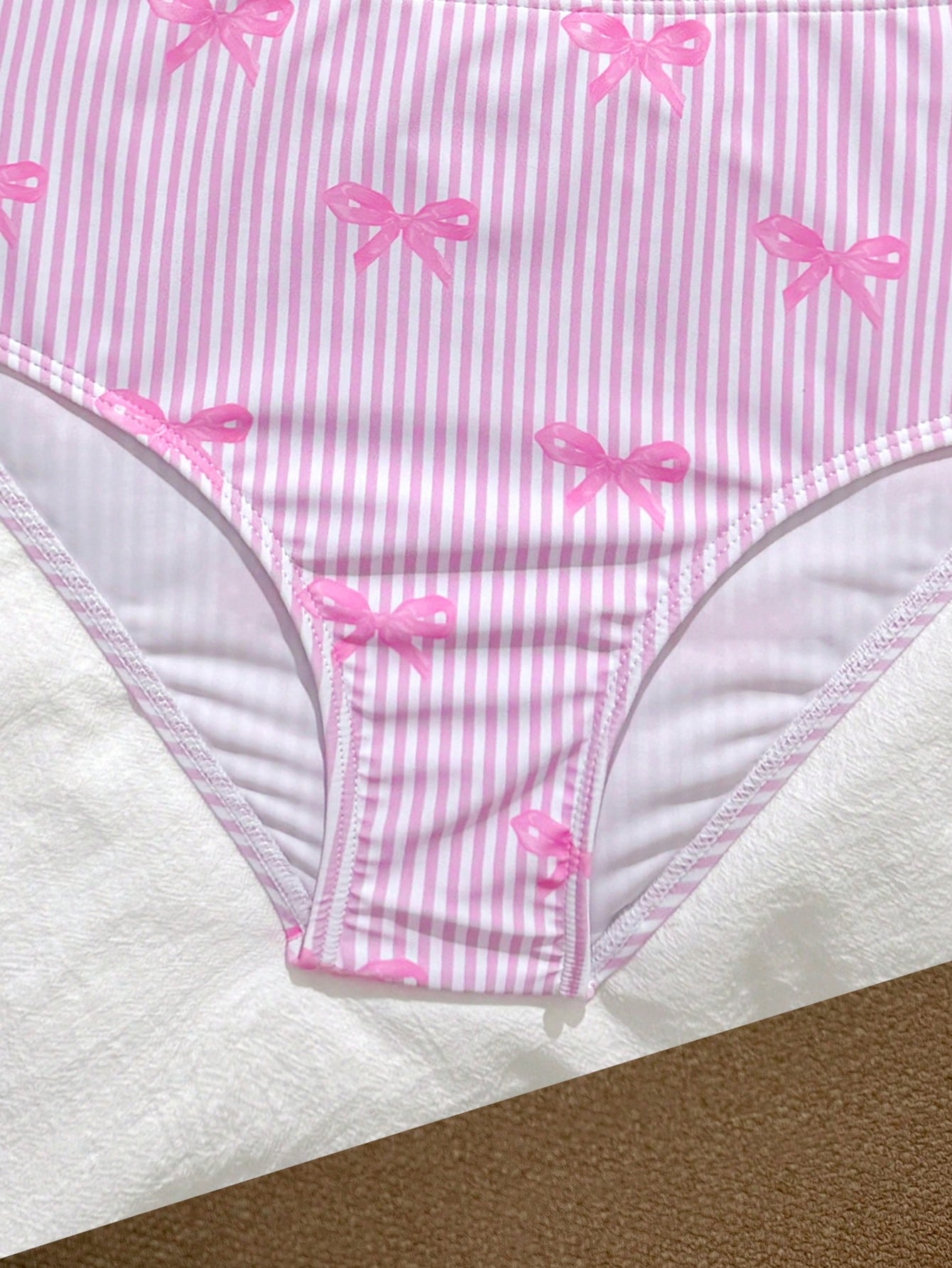 Tween girls 2-piece bikini swimwear set in black with a wave-pattern geometric design, featuring halter neckline, wireless top, and high-waist short bottoms with starfish and shell decor.