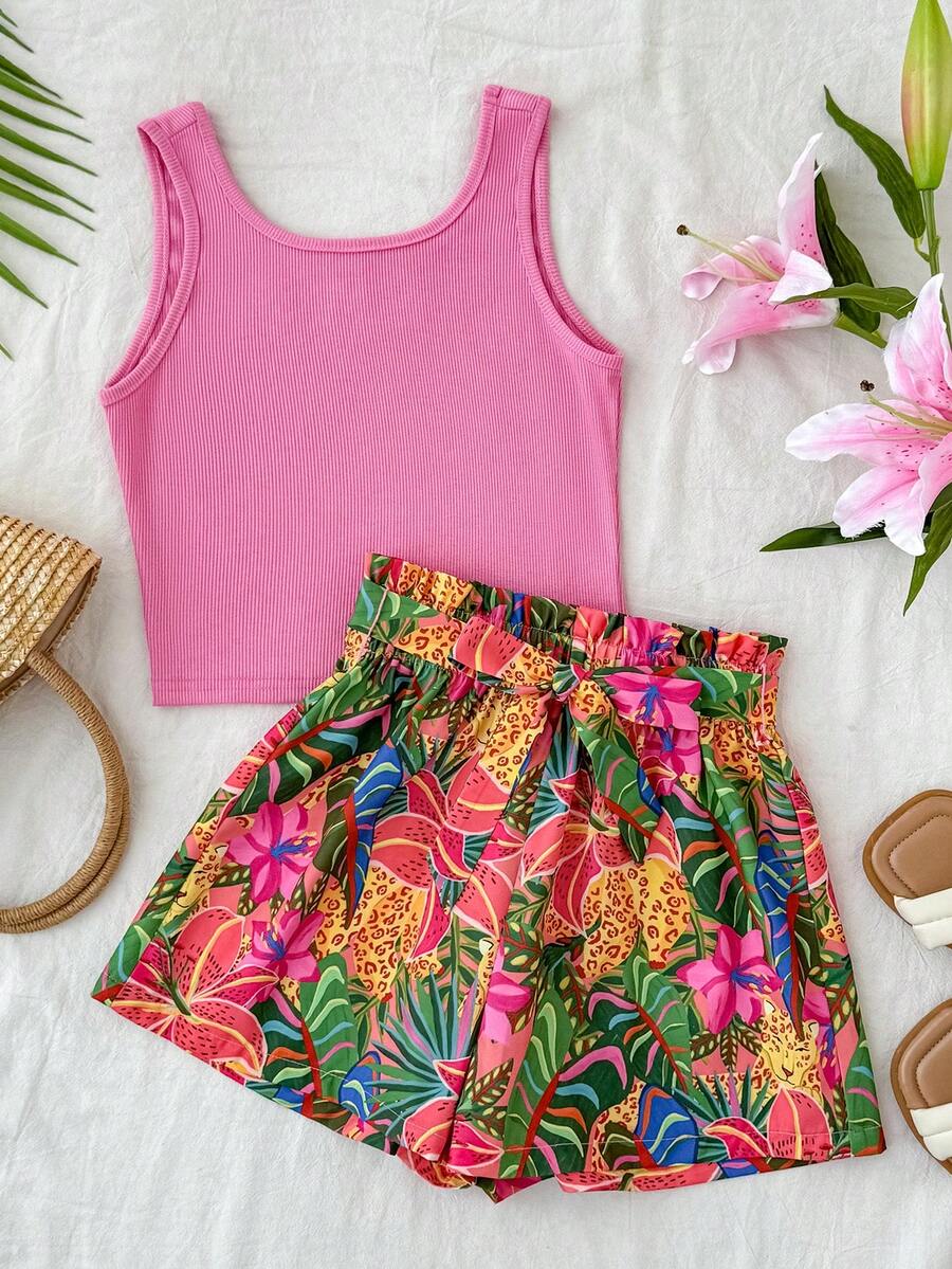 Tween girl wearing a casual 2-piece set featuring a black rib-knit scoop neck tank top and leopard print paperbag waist shorts with a matching belt.