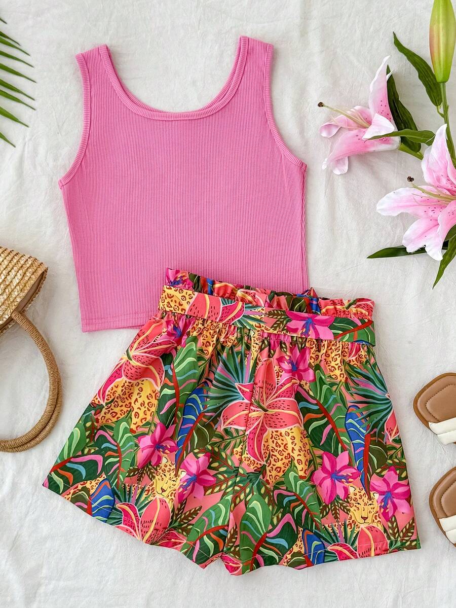 Tween girl wearing a casual 2-piece set featuring a black rib-knit scoop neck tank top and leopard print paperbag waist shorts with a matching belt.