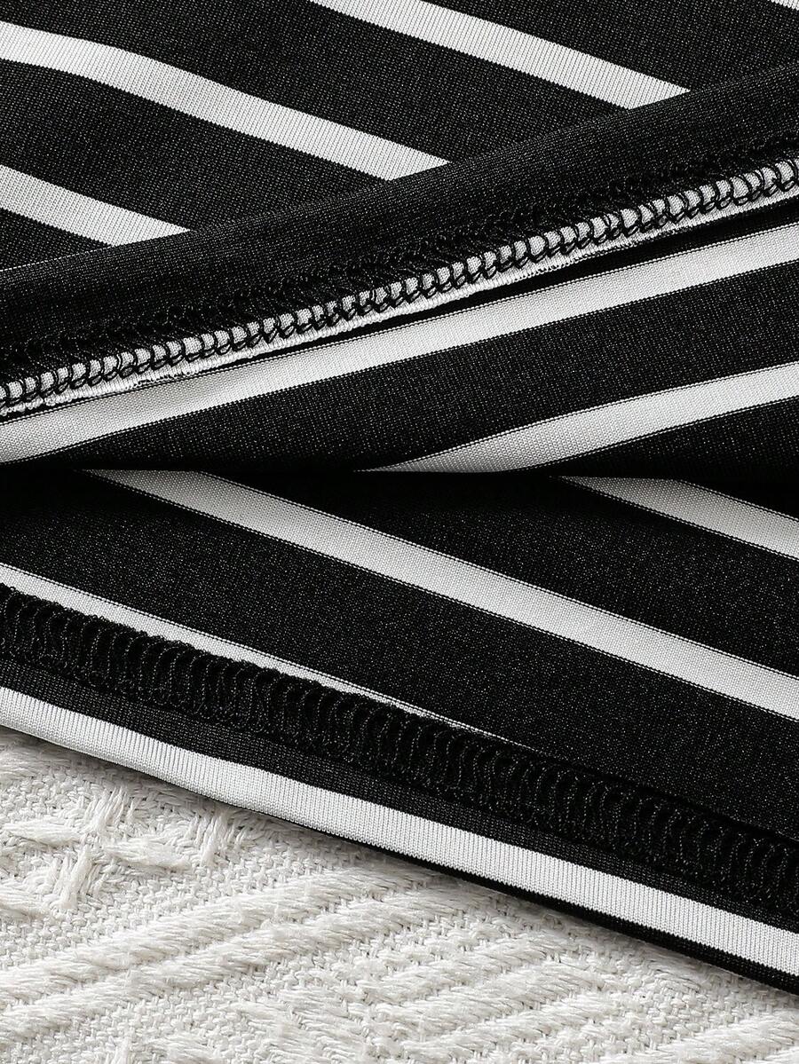 Girls black striped midi dress featuring short sleeves, round neck, slim fit, and flared hem.