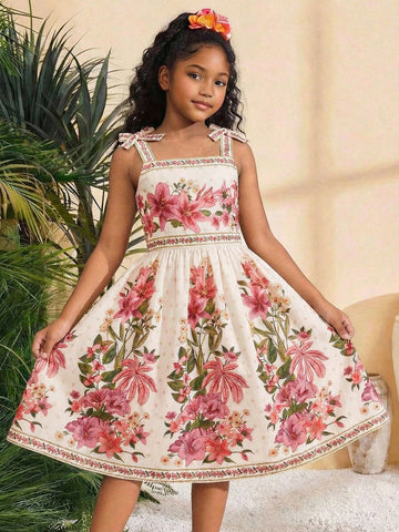 Tween girls multicolor floral print cami dress with spaghetti straps, shirred detail, belted high waist, zipper closure, and flared short hem.