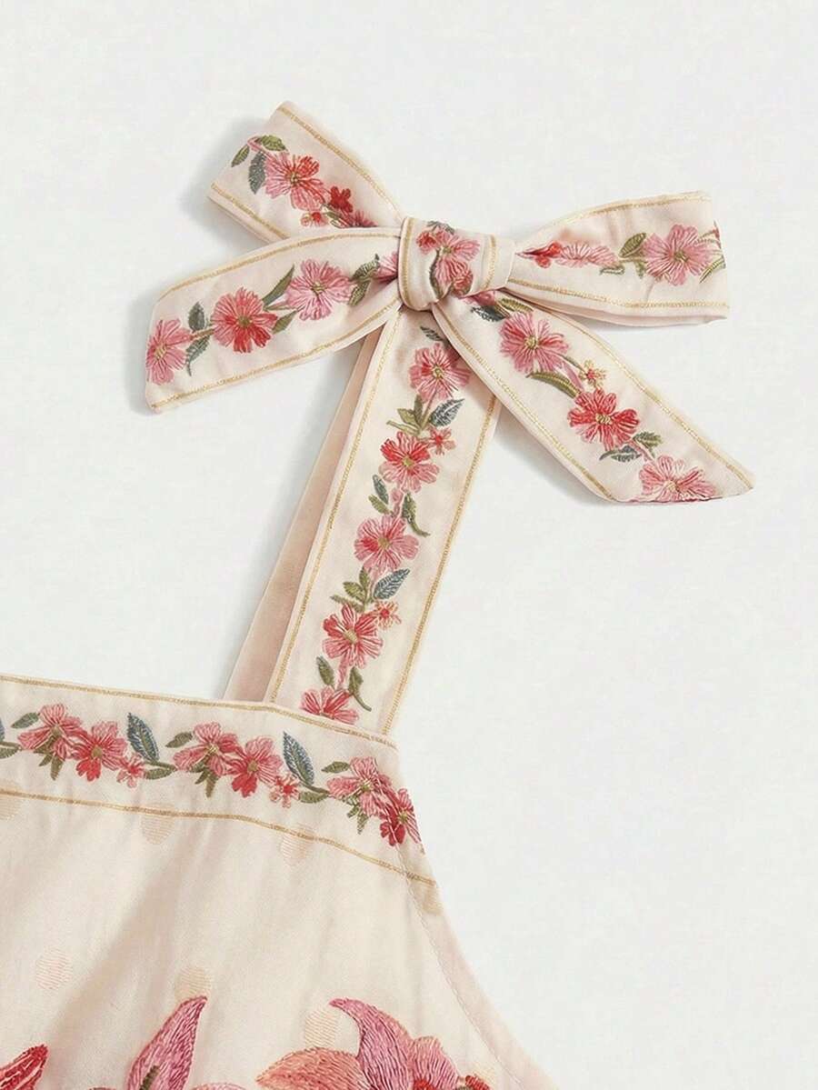 Tween girls multicolor floral print cami dress with spaghetti straps, shirred detail, belted high waist, zipper closure, and flared short hem.