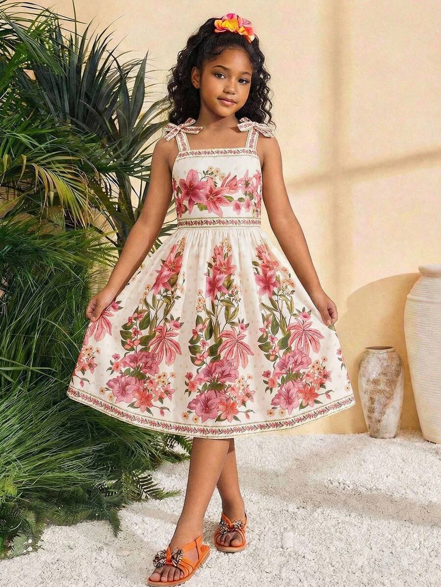 Tween girls multicolor floral print cami dress with spaghetti straps, shirred detail, belted high waist, zipper closure, and flared short hem.