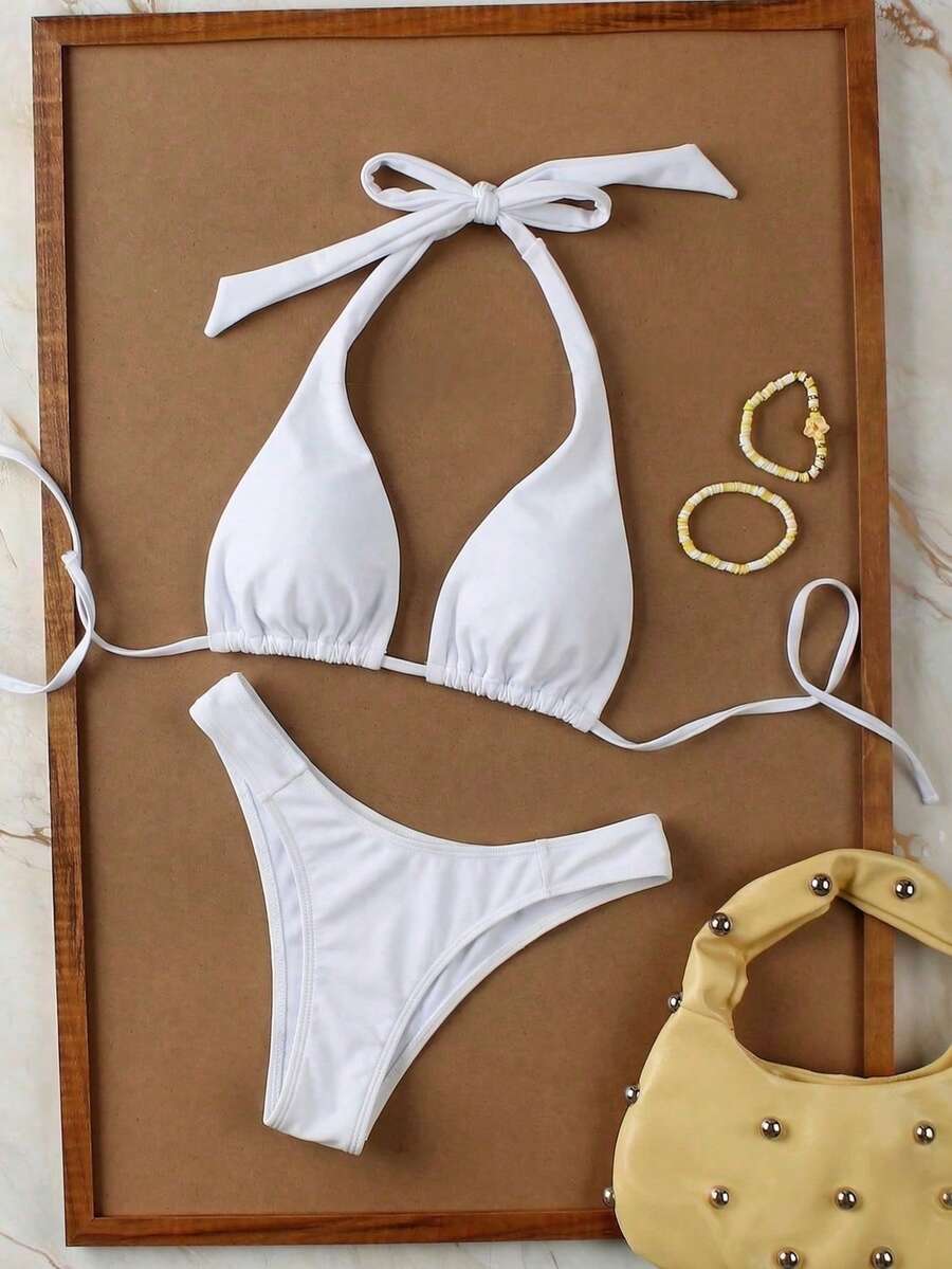 Women's halter neck bikini swimwear set featuring a wireless bra top with removable padding and mid waist bikini bottom.