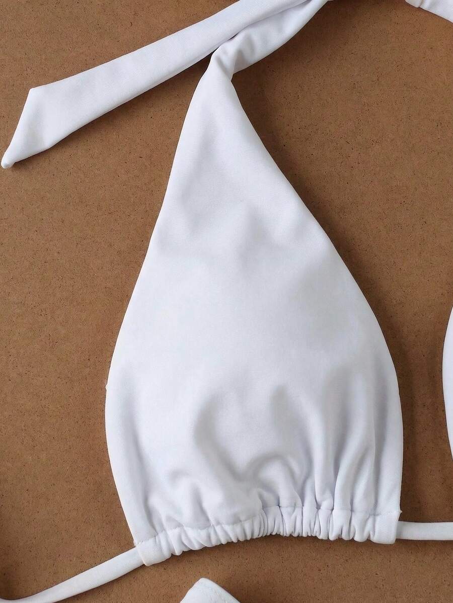Women's halter neck bikini swimwear set featuring a wireless bra top with removable padding and mid waist bikini bottom.