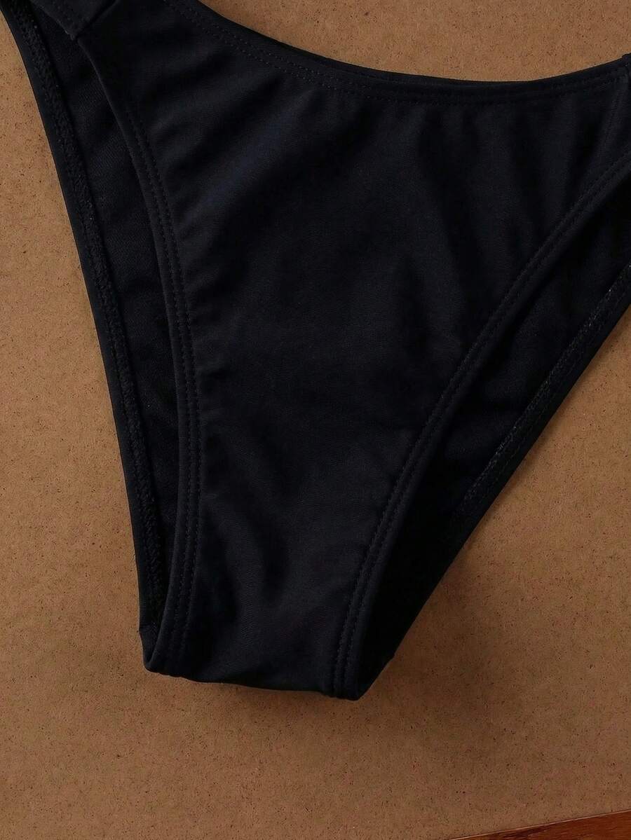 Women's halter neck bikini swimwear set featuring a wireless bra top with removable padding and mid waist bikini bottom.