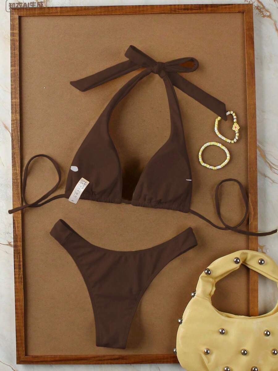 Women's halter neck bikini swimwear set featuring a wireless bra top with removable padding and mid waist bikini bottom.