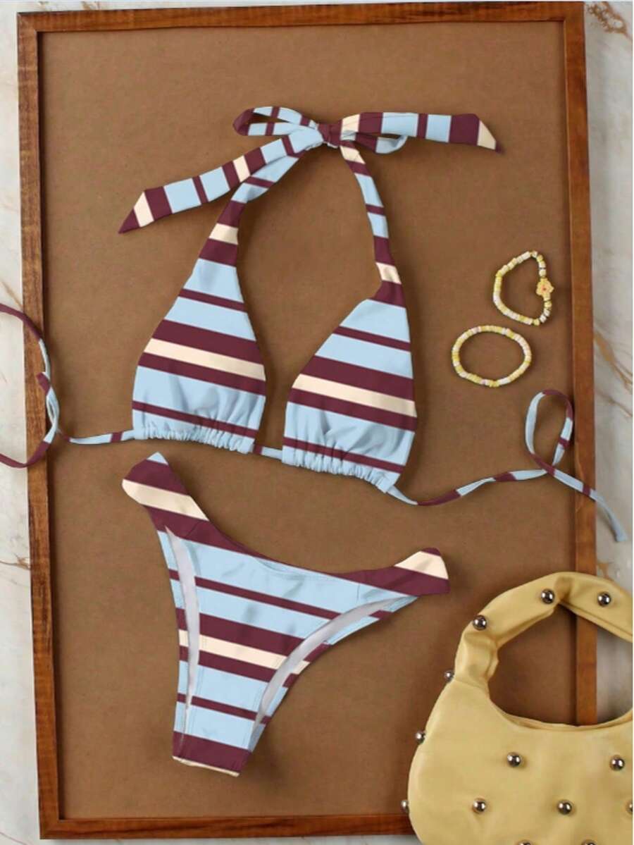 Women's halter neck bikini swimwear set featuring a wireless bra top with removable padding and mid waist bikini bottom.