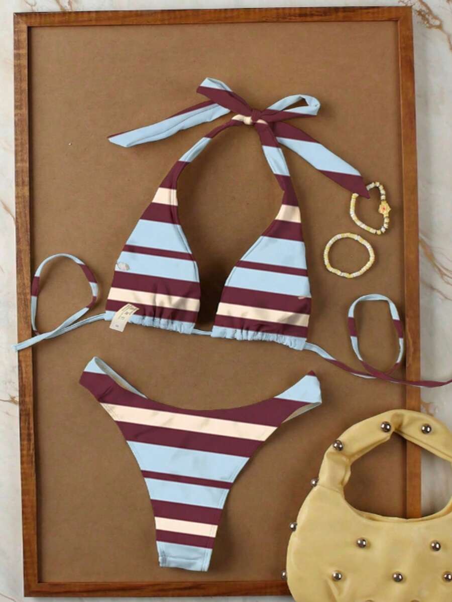 Women's halter neck bikini swimwear set featuring a wireless bra top with removable padding and mid waist bikini bottom.