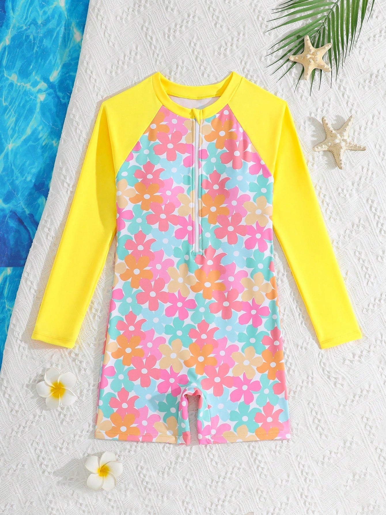 Tween girls one-piece swimsuit featuring a high neck, long sleeves, and shorts bottom, with a back zipper and strawberry plaid digital print on stretch knit fabric. Designed for swimming, vacation, and summer wear.