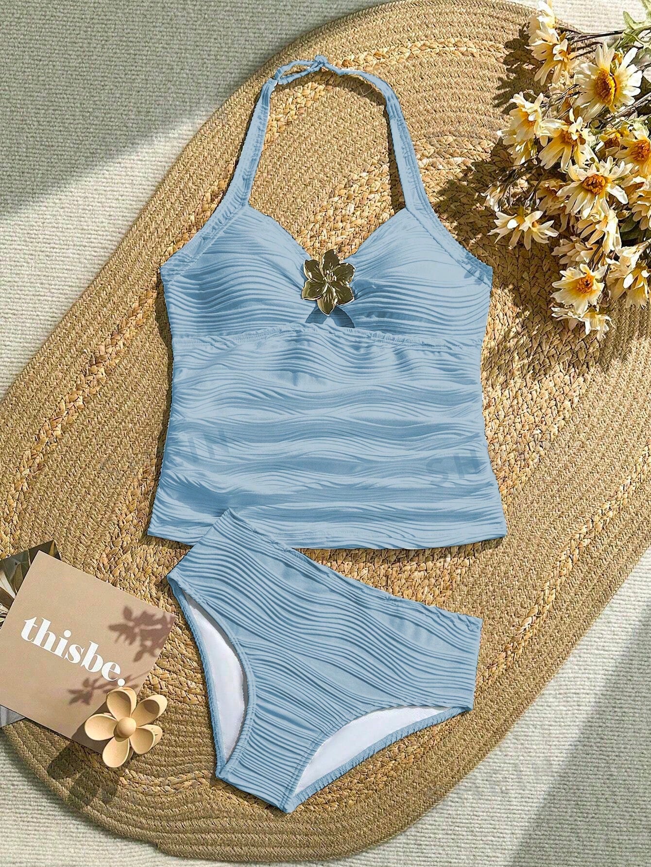 Tween girls 2-piece bikini swimwear set in black with a wave-pattern geometric design, featuring halter neckline, wireless top, and high-waist short bottoms with starfish and shell decor.