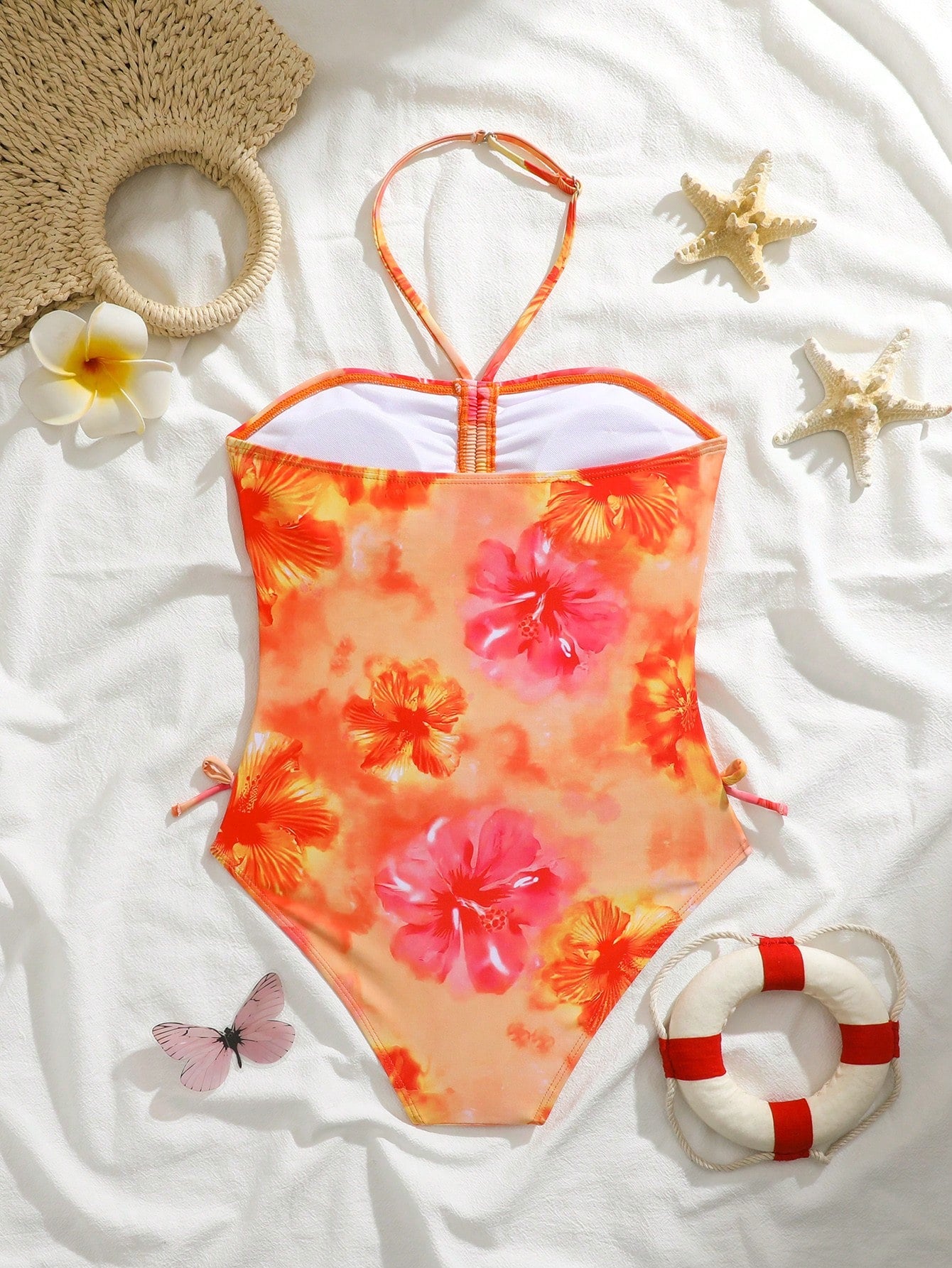 Blue halter one-piece swimsuit for tween girls with full geometric print, wireless bra design, mid-waist bottom, and medium-stretch fabric for beach and pool wear.