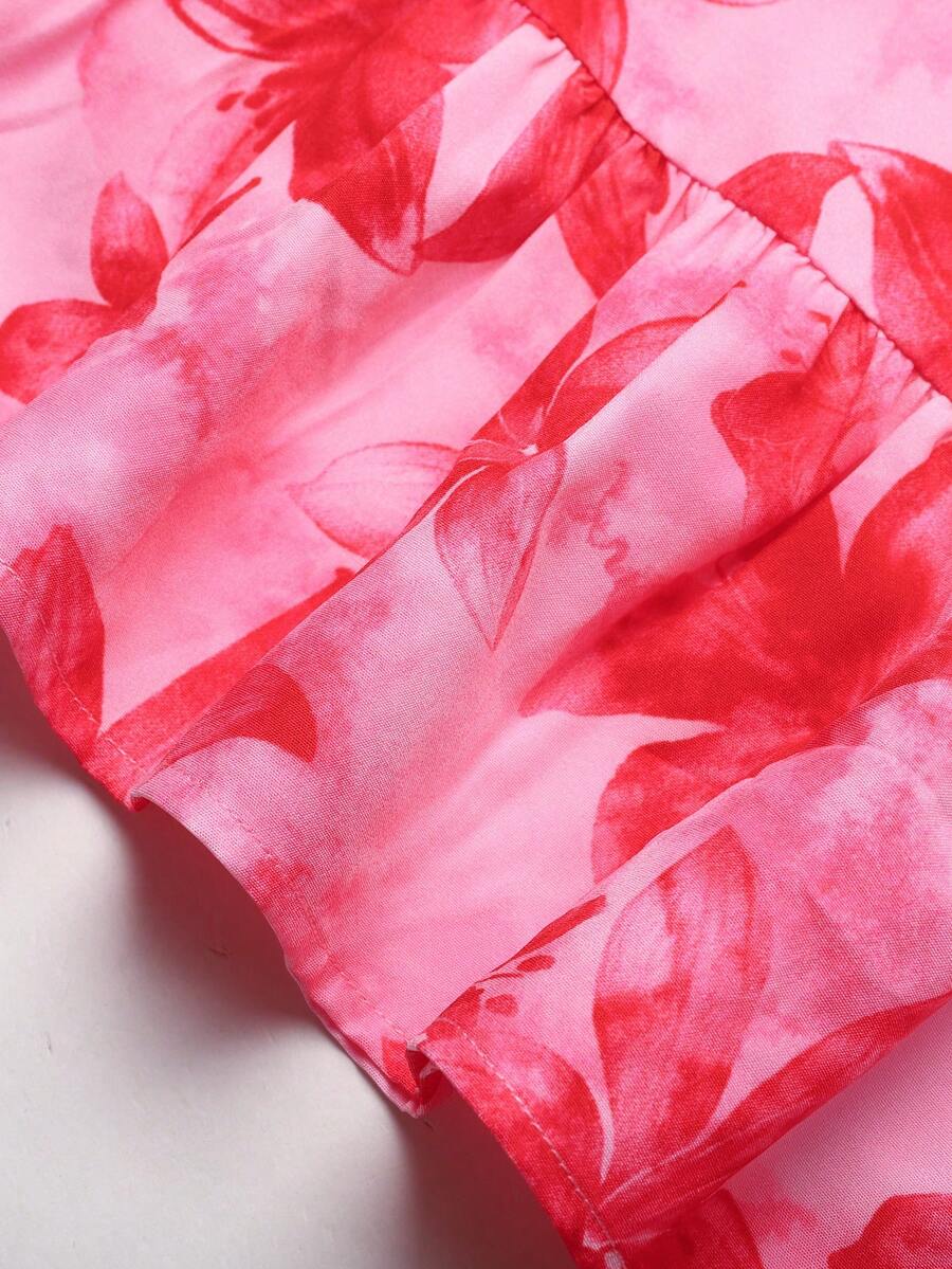 Pink sleeveless tween girls vacation dress with all-over fruit and vegetable print, strap neckline, belted high waist, cut-out detail, and flared ruffle hem.