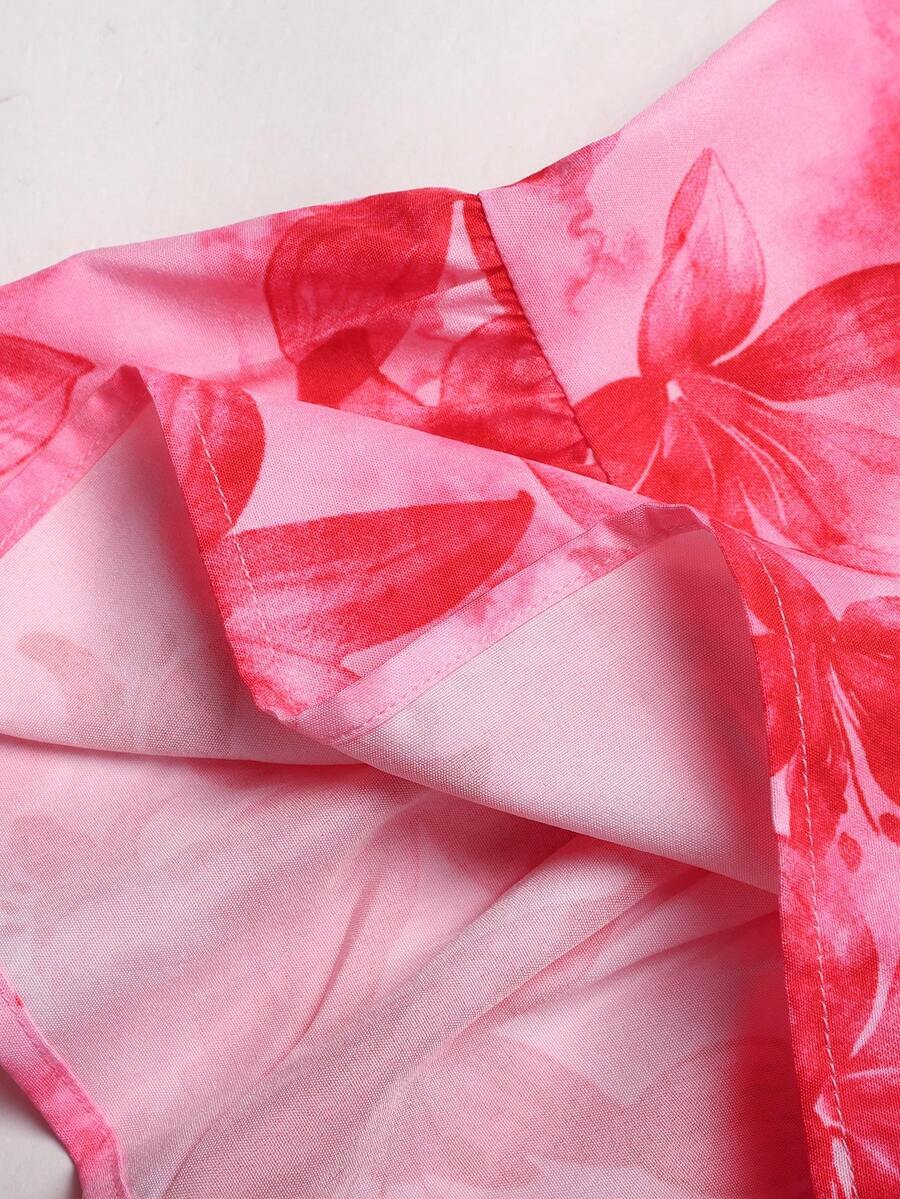 Pink sleeveless tween girls vacation dress with all-over fruit and vegetable print, strap neckline, belted high waist, cut-out detail, and flared ruffle hem.