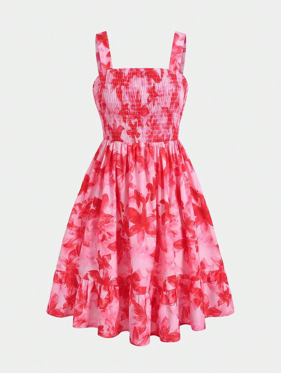 Pink sleeveless tween girls vacation dress with all-over fruit and vegetable print, strap neckline, belted high waist, cut-out detail, and flared ruffle hem.
