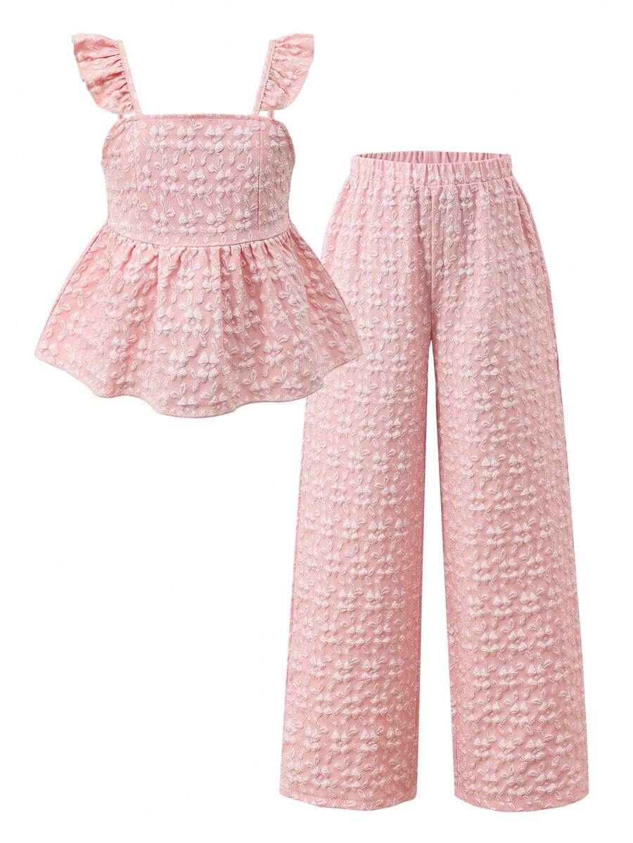 Tween girl wearing an apricot 2-piece outfit set featuring a shirred spaghetti strap short cami top and matching wide-leg long pants.
