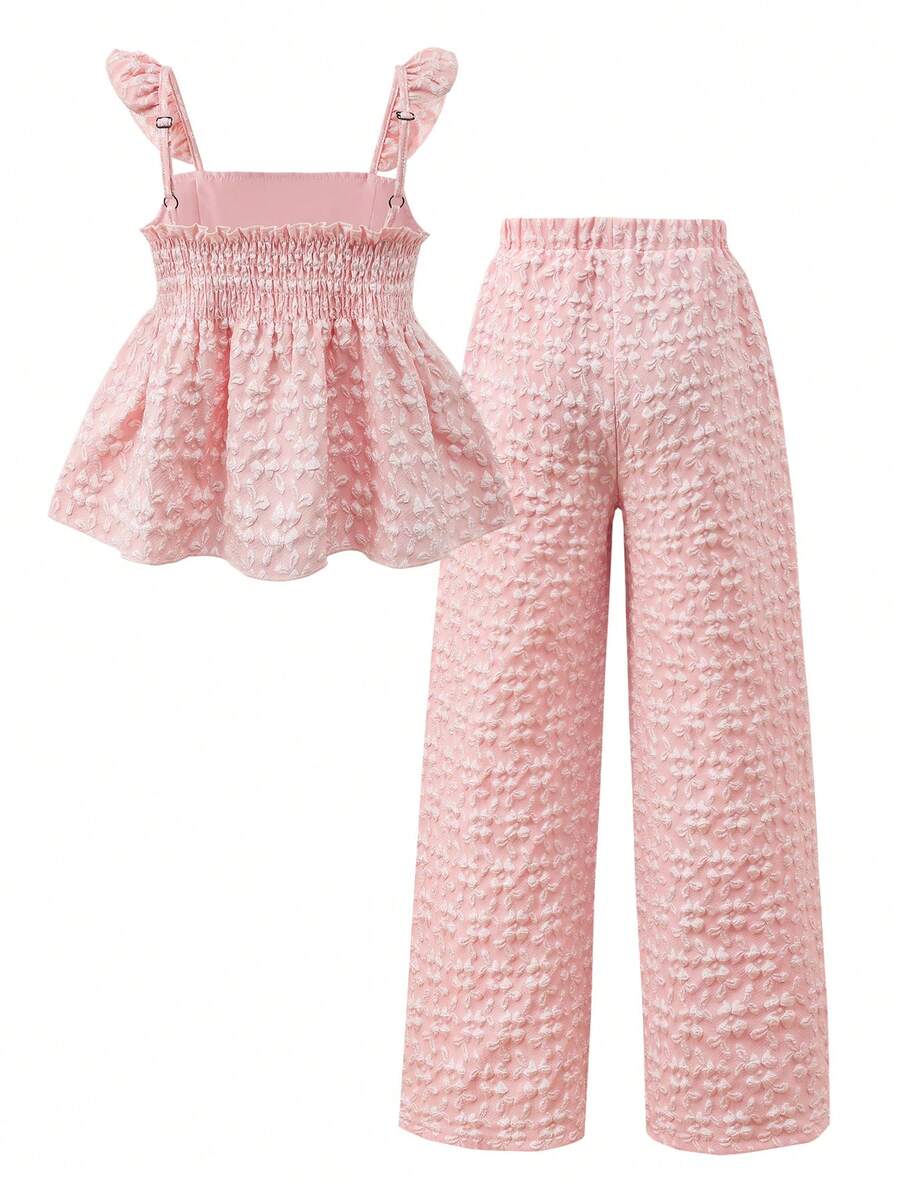Tween girl wearing an apricot 2-piece outfit set featuring a shirred spaghetti strap short cami top and matching wide-leg long pants.