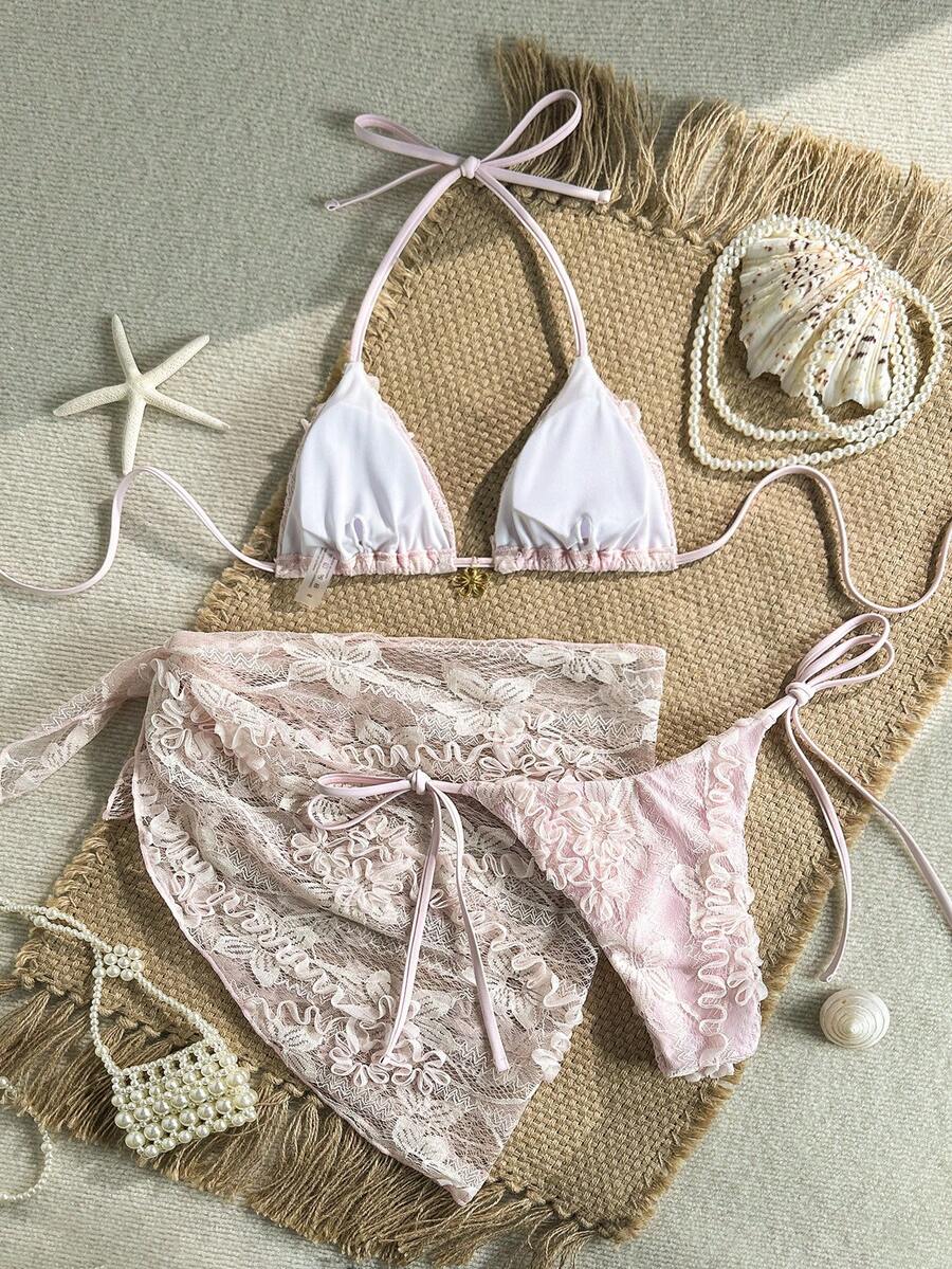 Women's 3-piece blue tropical shell print bikini set featuring a halter bralette top, low-waist tie-side bottom, and a matching sheer mesh cover-up skirt.