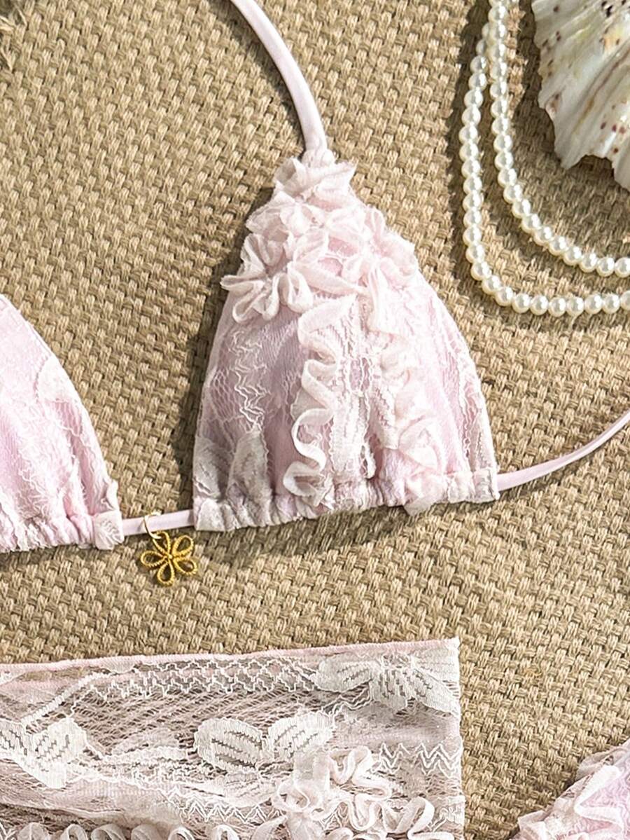 Women's 3-piece blue tropical shell print bikini set featuring a halter bralette top, low-waist tie-side bottom, and a matching sheer mesh cover-up skirt.