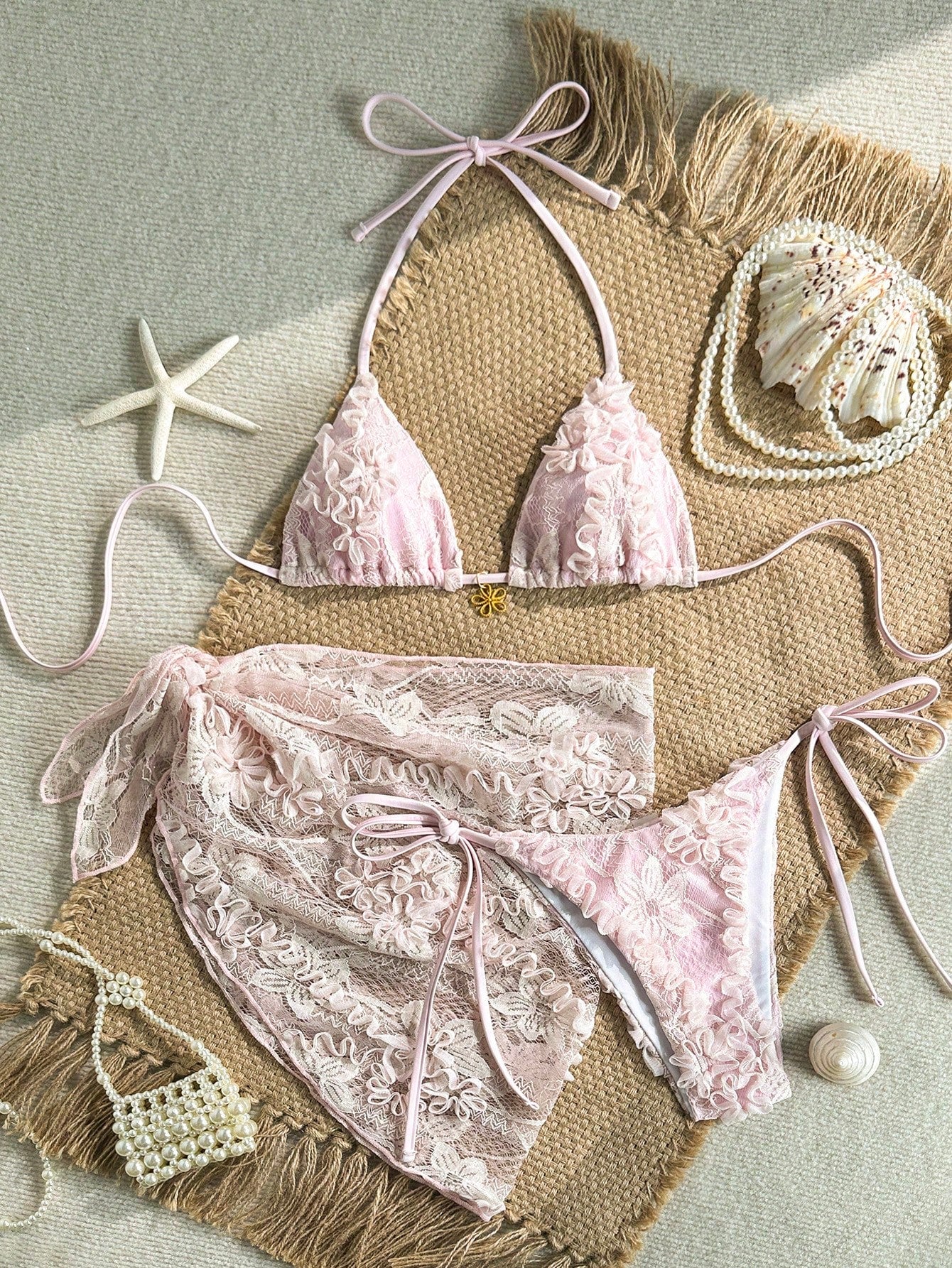 Women's 3-piece blue tropical shell print bikini set featuring a halter bralette top, low-waist tie-side bottom, and a matching sheer mesh cover-up skirt.