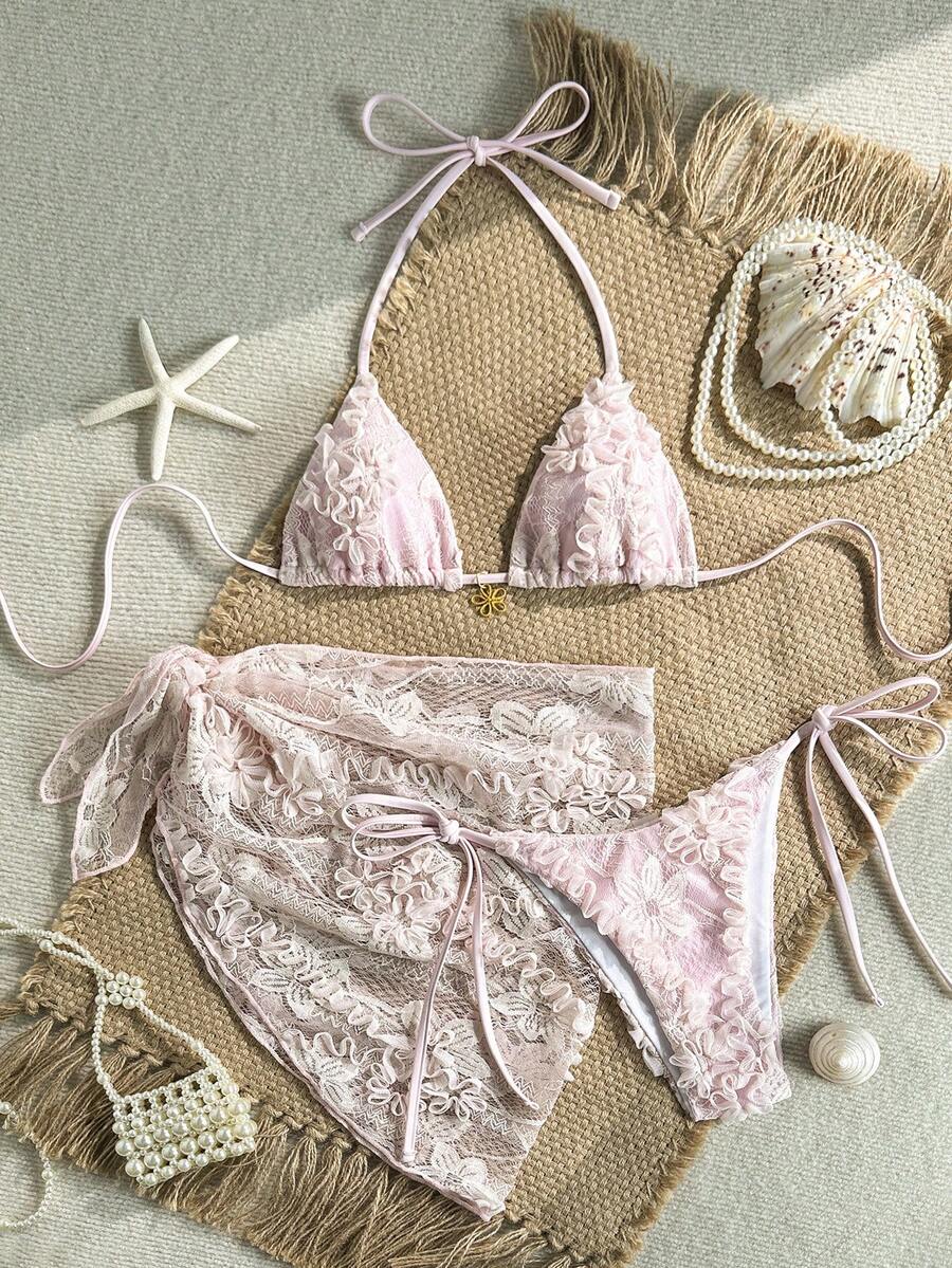 Women's 3-piece blue tropical shell print bikini set featuring a halter bralette top, low-waist tie-side bottom, and a matching sheer mesh cover-up skirt.