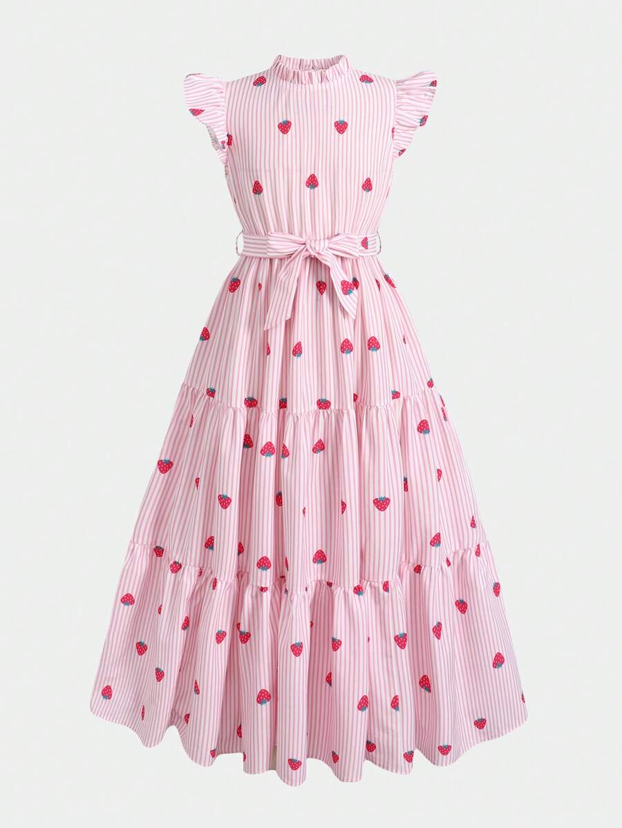 Tween girl wearing a pink long A-line dress featuring a strawberry print, stand collar, flounce short sleeves, and a belted waist with a ruffle hem.