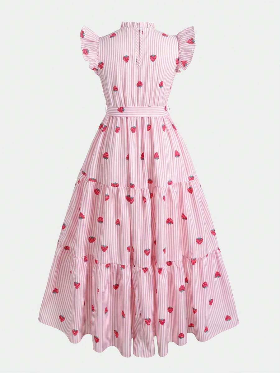Tween girl wearing a pink long A-line dress featuring a strawberry print, stand collar, flounce short sleeves, and a belted waist with a ruffle hem.