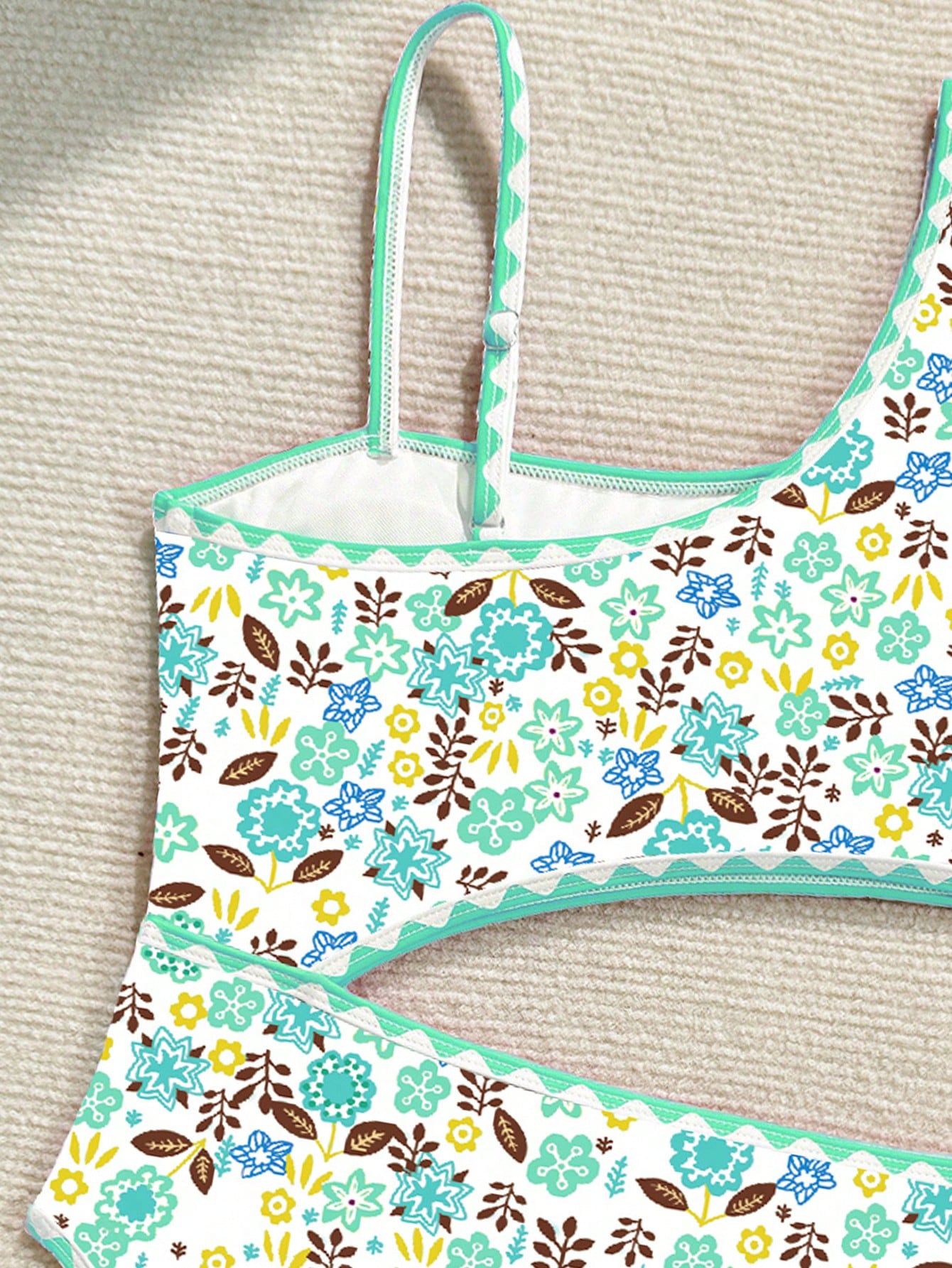 Tween girl one-piece swimsuit with floral plant print, asymmetrical neckline, cut-out detail, and fitted high-stretch design for beach and pool wear