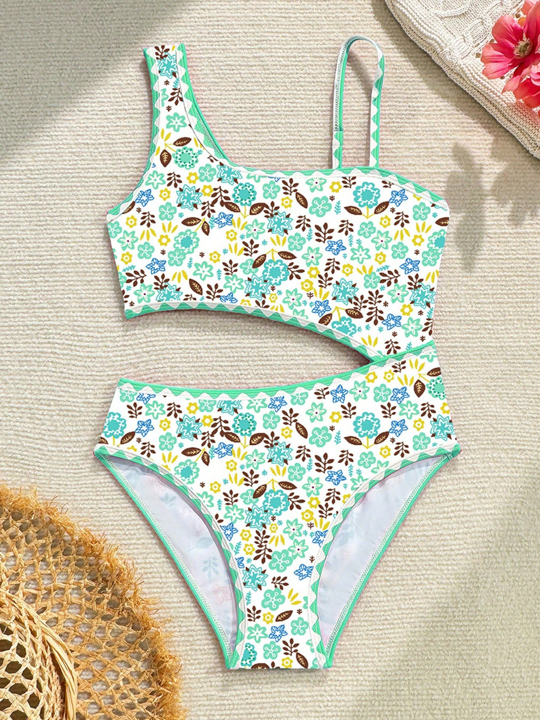 Tween girl one-piece swimsuit with floral plant print, asymmetrical neckline, cut-out detail, and fitted high-stretch design for beach and pool wear