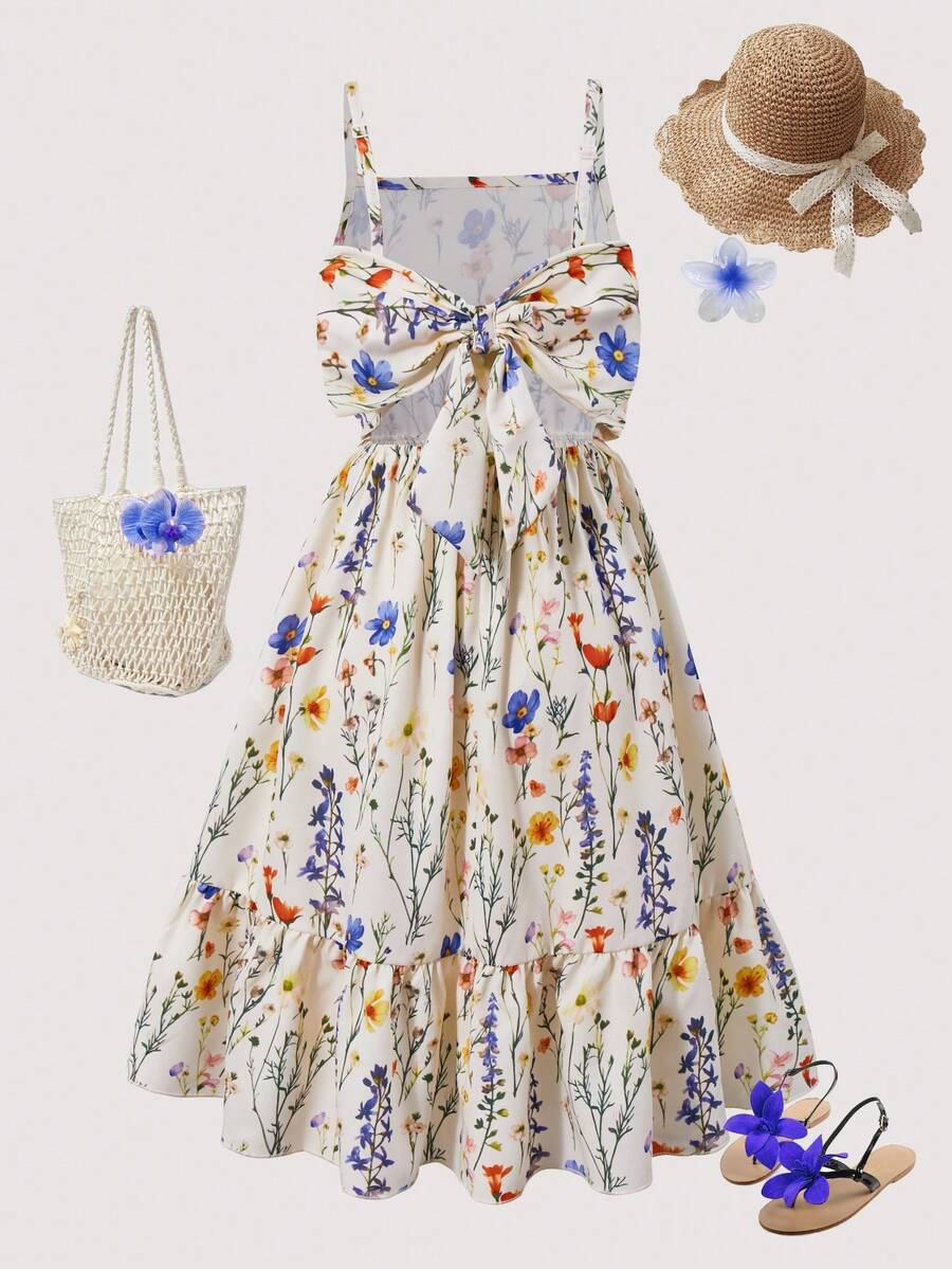 Tween girl wearing an apricot floral print sleeveless mini cami dress featuring spaghetti straps, a shirred high waist, flounce hem, and a bow back detail.