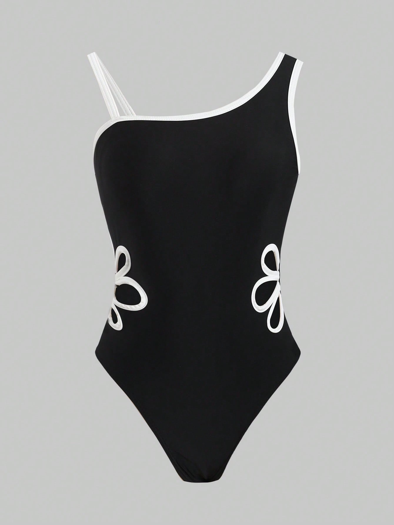 Tween girl one-piece swimsuit in brown polka dot geometric print with asymmetrical neckline, ruffle detail, cut-out design, and fitted mid-waist swim bottom.