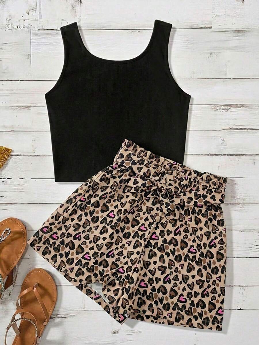 Tween girl wearing a casual 2-piece set featuring a black rib-knit scoop neck tank top and leopard print paperbag waist shorts with a matching belt.