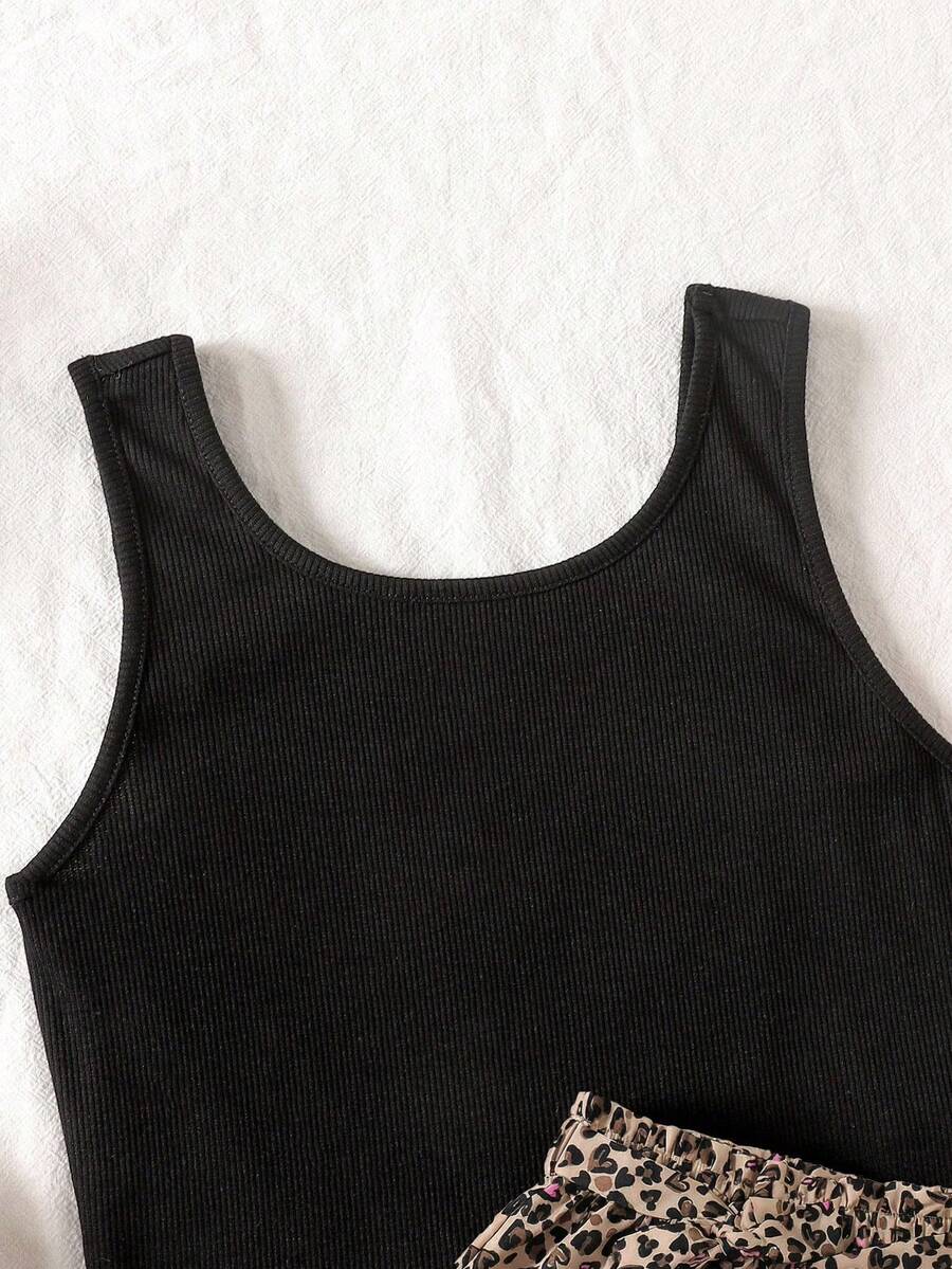 Tween girl wearing a casual 2-piece set featuring a black rib-knit scoop neck tank top and leopard print paperbag waist shorts with a matching belt.