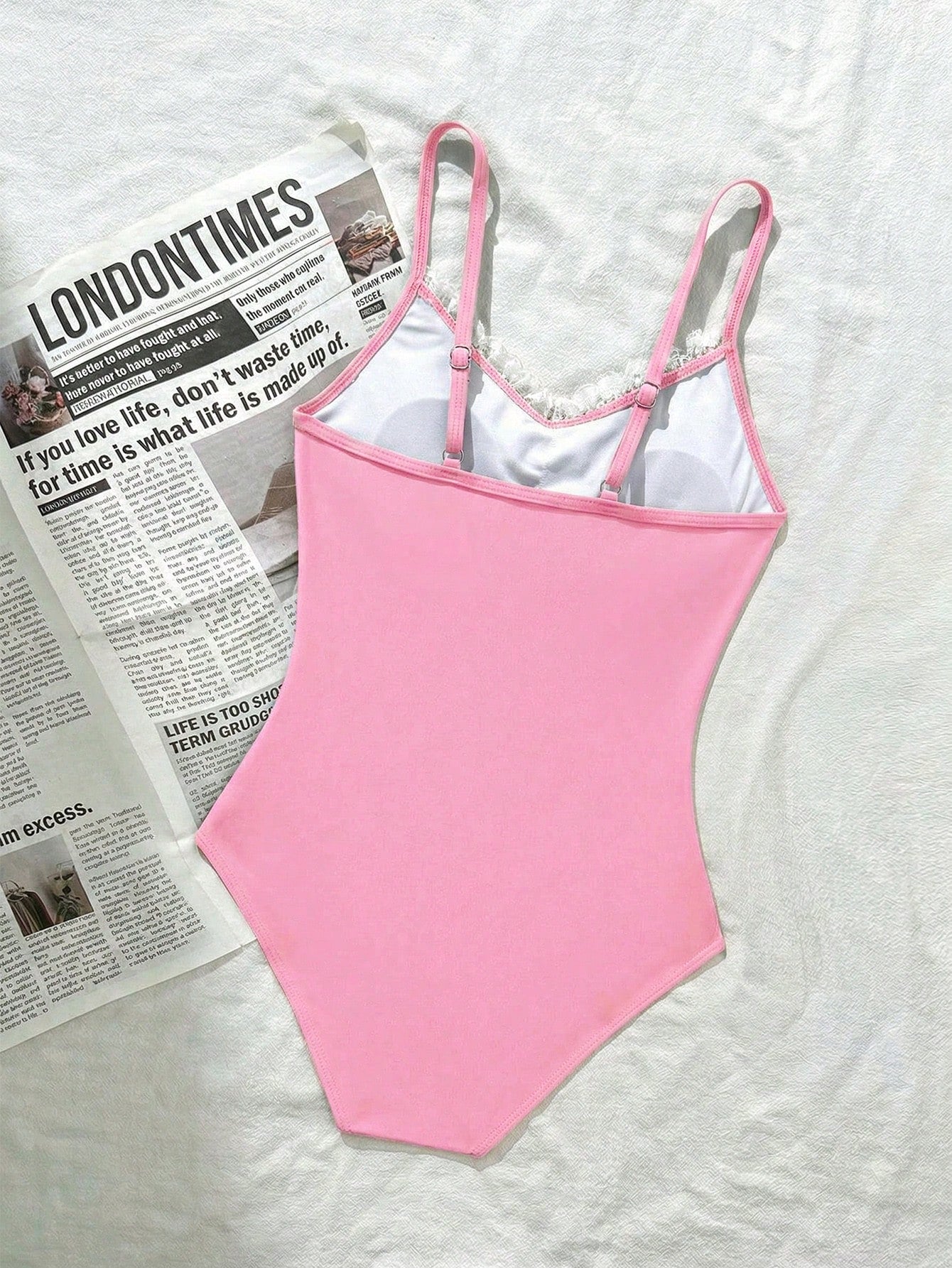 Tween girls' one-piece swimsuit featuring a ruffle splice front, ruched detailing, bow accent, contrast lace trim, and spaghetti straps.