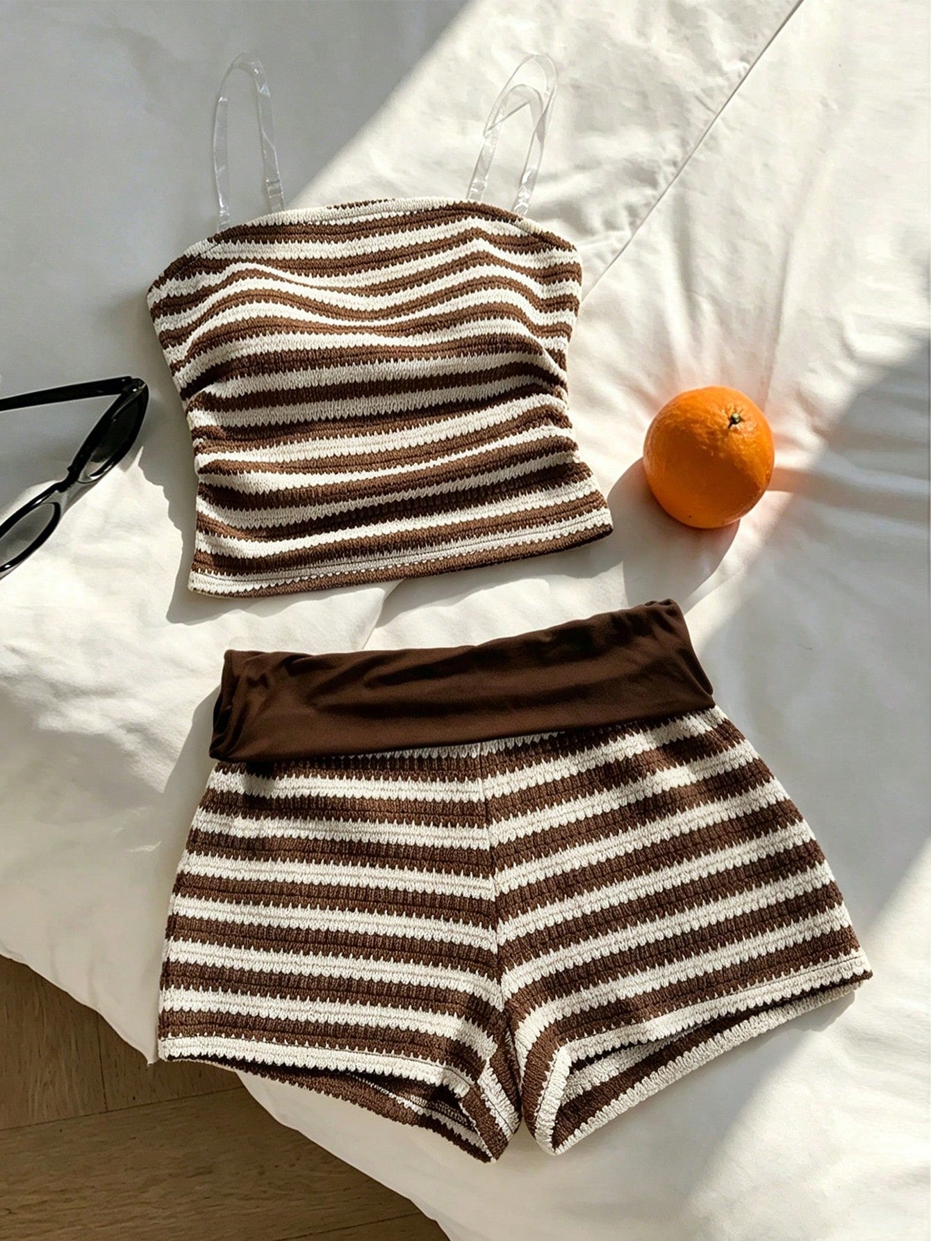 Tween girls black and white striped two-piece set featuring a spaghetti strap micro crop tank top with lettuce trim and ruffle hem paired with matching slim fit shorts.