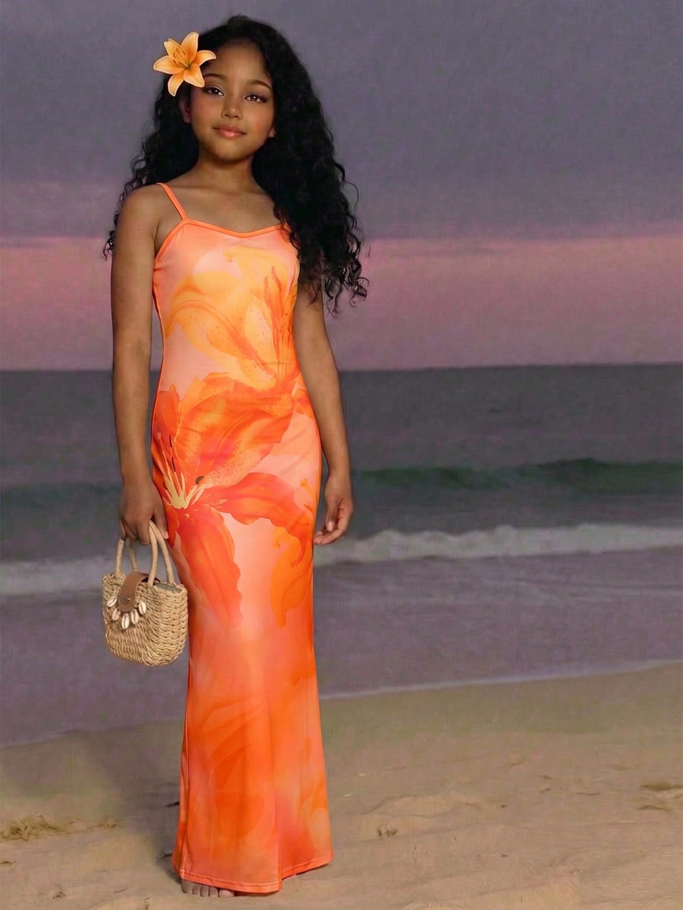 Tween girls black cami midi dress featuring plant print, spaghetti straps, slim fit, and a flared hem.