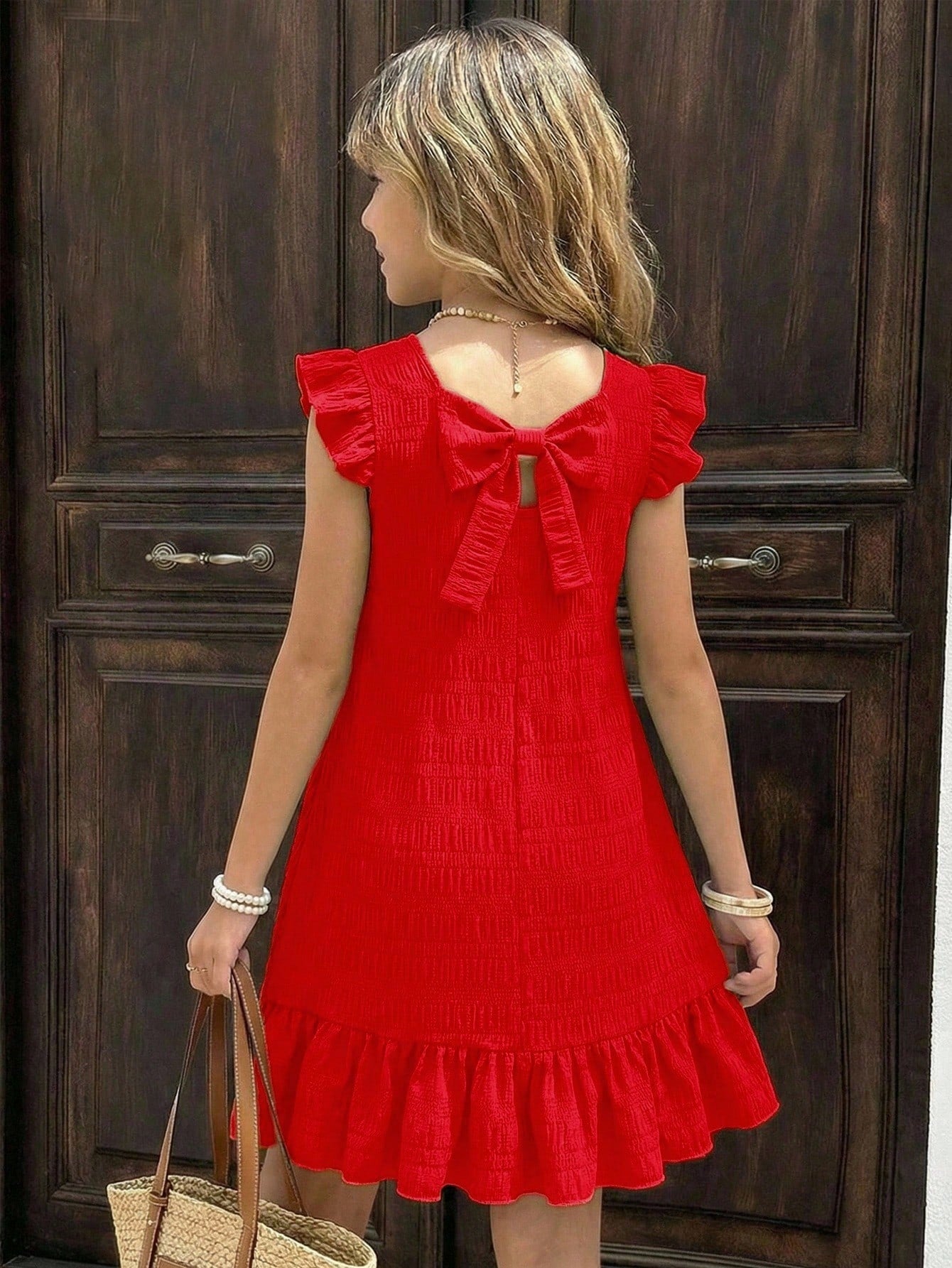 Tween girls apricot vacation midi dress featuring a round neck, cut out details, ruffle flounce accents, and geometric pattern.