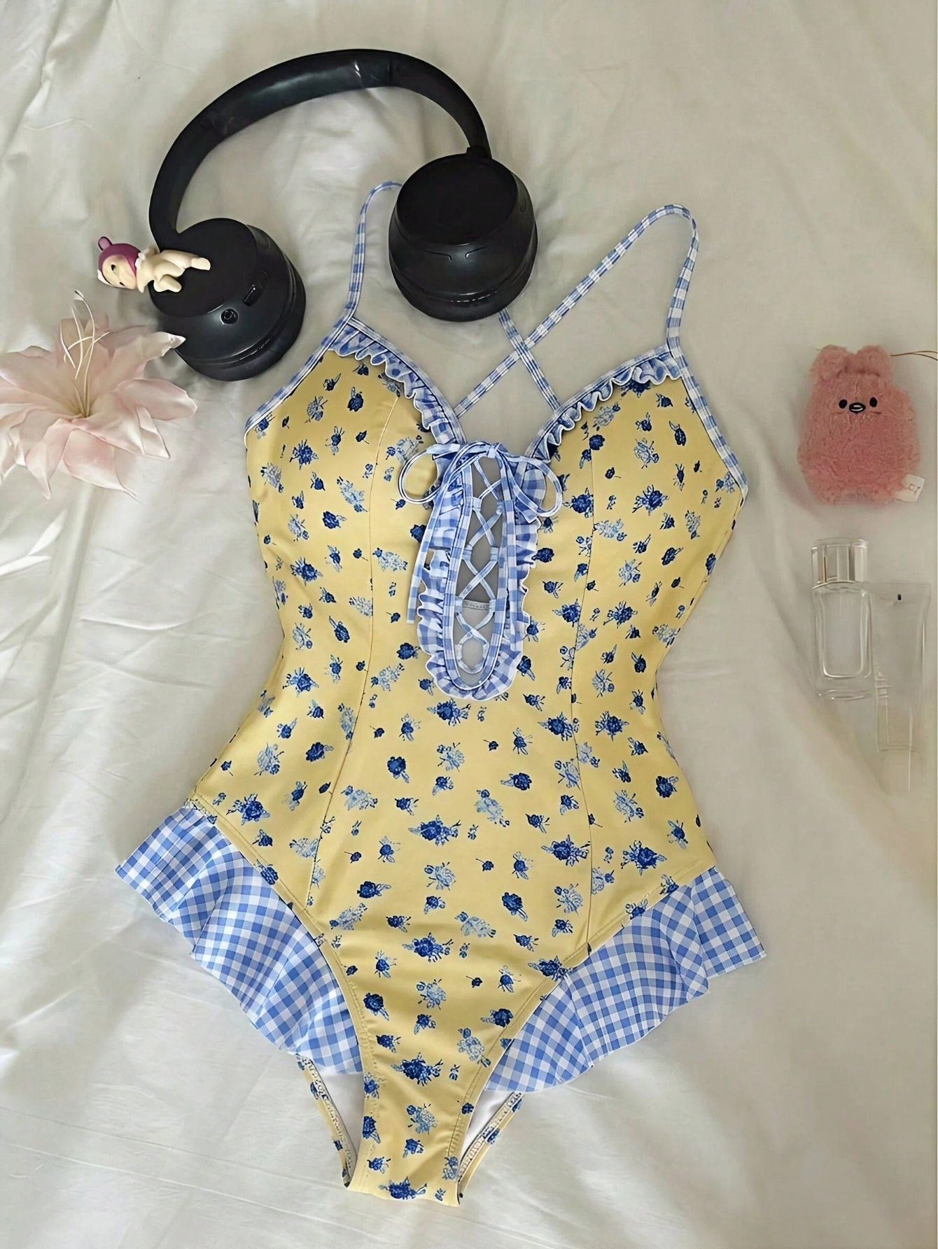 Women's strawberry print one-piece swimsuit featuring ruffle details, front-tie design, backless criss-cross straps, and triangle wireless cups.
