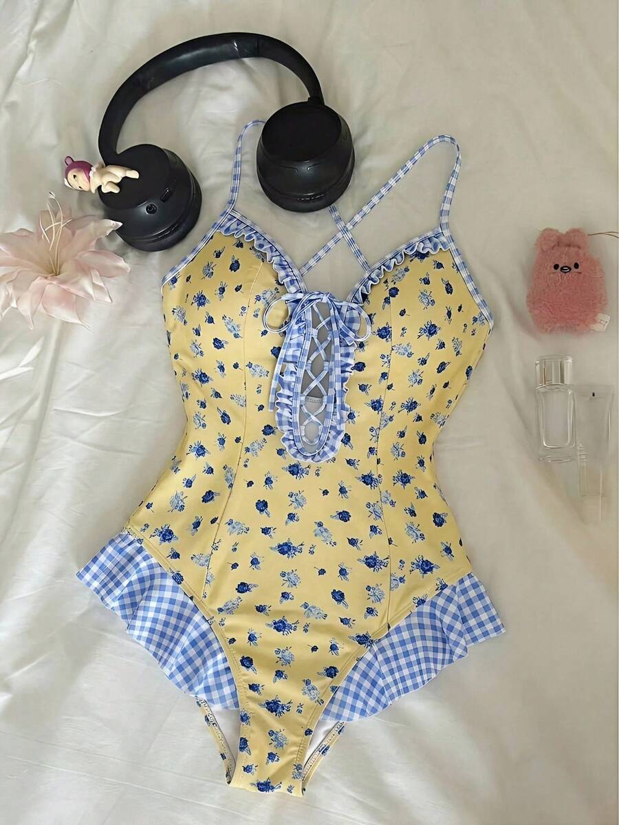 Women's strawberry print one-piece swimsuit featuring ruffle details, front-tie design, backless criss-cross straps, and triangle wireless cups.
