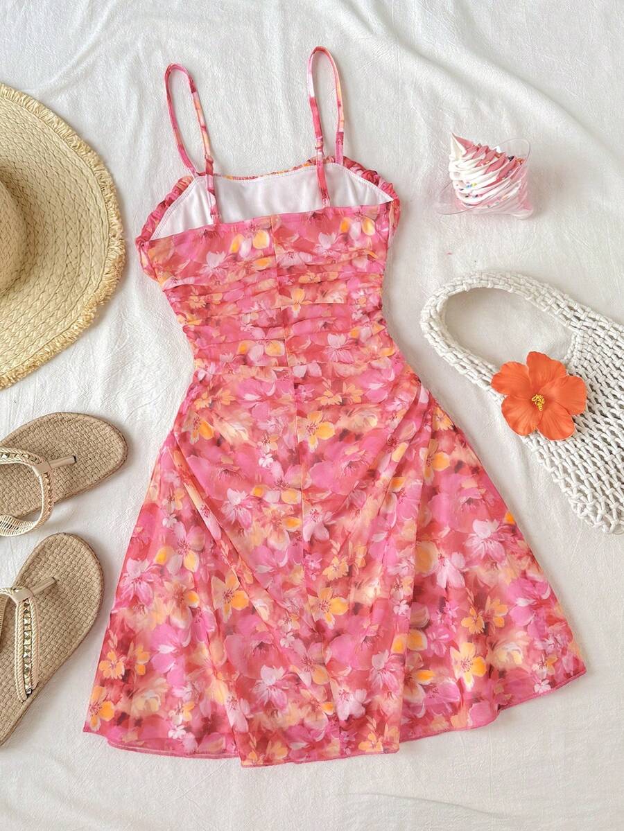 Tween girl yellow mini sundress with large pink floral hibiscus print, spaghetti straps, high waist, flared hem, and sleeveless cami style for summer beach wear