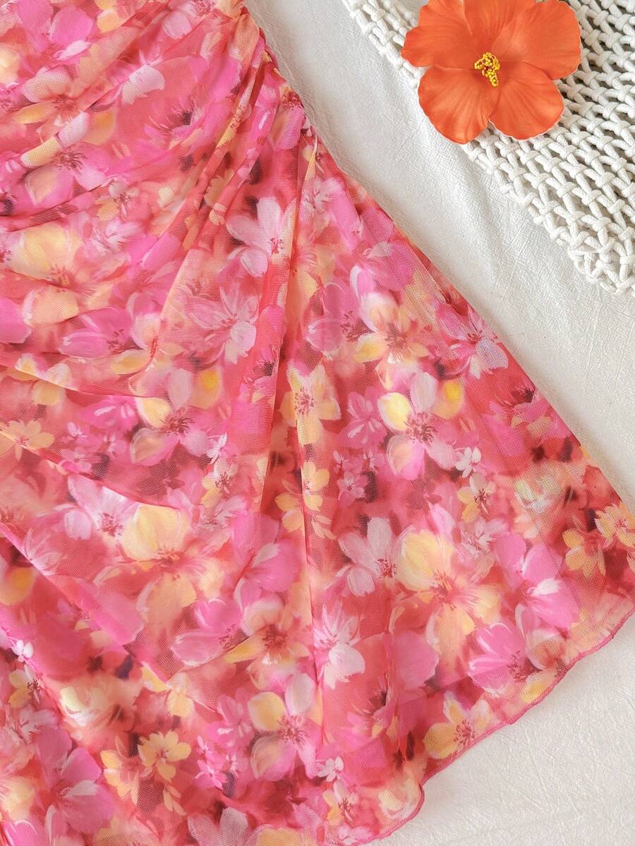 Tween girl yellow mini sundress with large pink floral hibiscus print, spaghetti straps, high waist, flared hem, and sleeveless cami style for summer beach wear