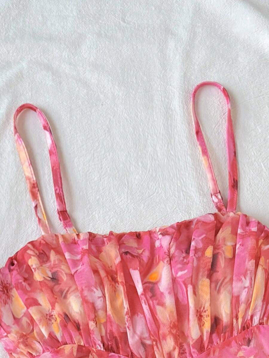 Tween girl yellow mini sundress with large pink floral hibiscus print, spaghetti straps, high waist, flared hem, and sleeveless cami style for summer beach wear
