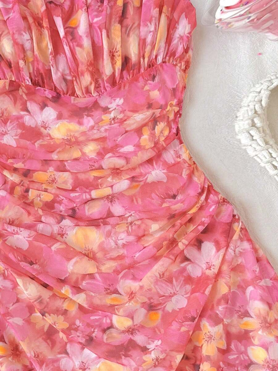 Tween girl yellow mini sundress with large pink floral hibiscus print, spaghetti straps, high waist, flared hem, and sleeveless cami style for summer beach wear