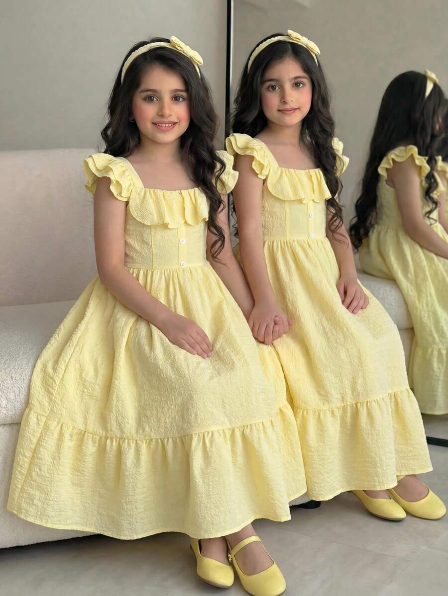 Blue floral print long vacation dress for tween girls featuring an A-line high waist silhouette with ruffle details and spaghetti straps.