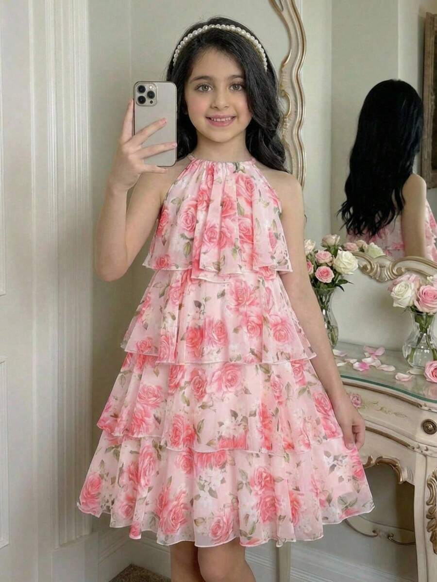 Apricot all-over floral print midi dress for tween girls featuring a sleeveless V-neckline, high waist, button details, and tiered A-line skirt.