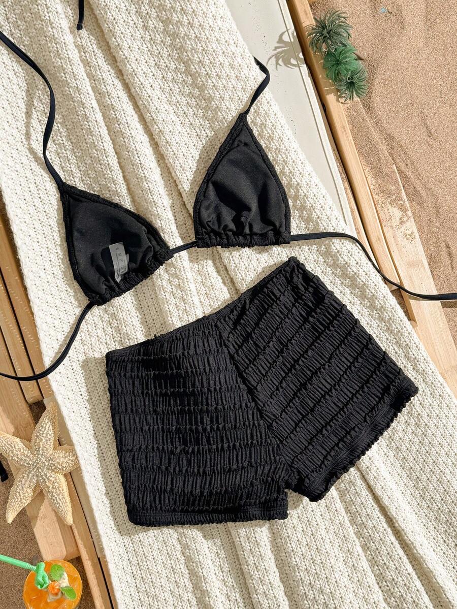 Women's apricot two-piece swimsuit set with a halter tie-back top and matching high stretch shorts.
